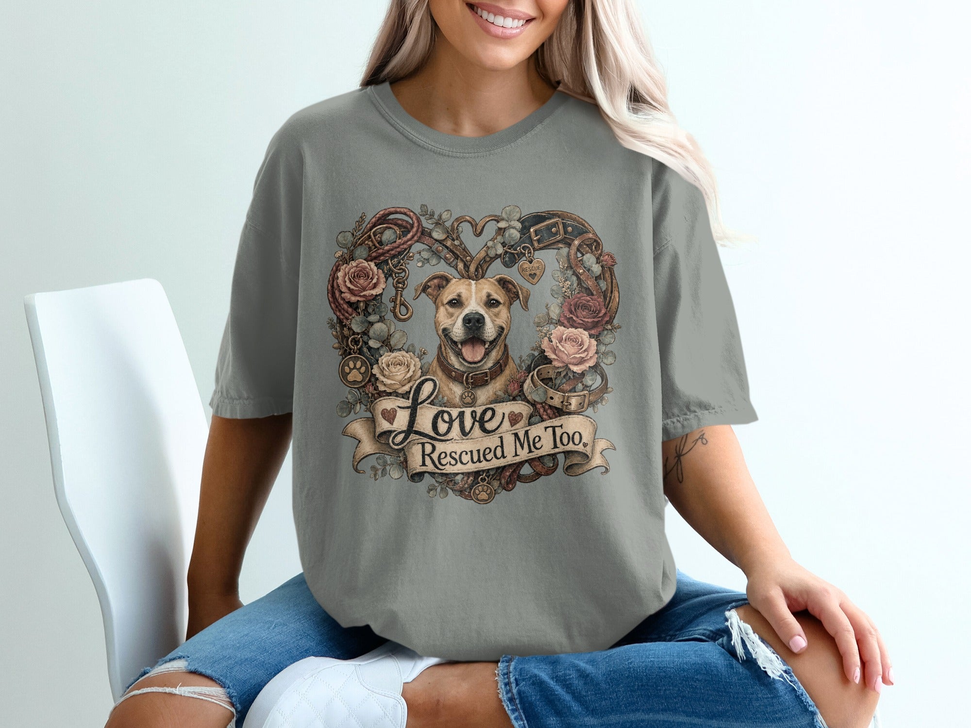 Dog with roses and leash art reads "Love Rescued Me Too" on a grey t-shirt.