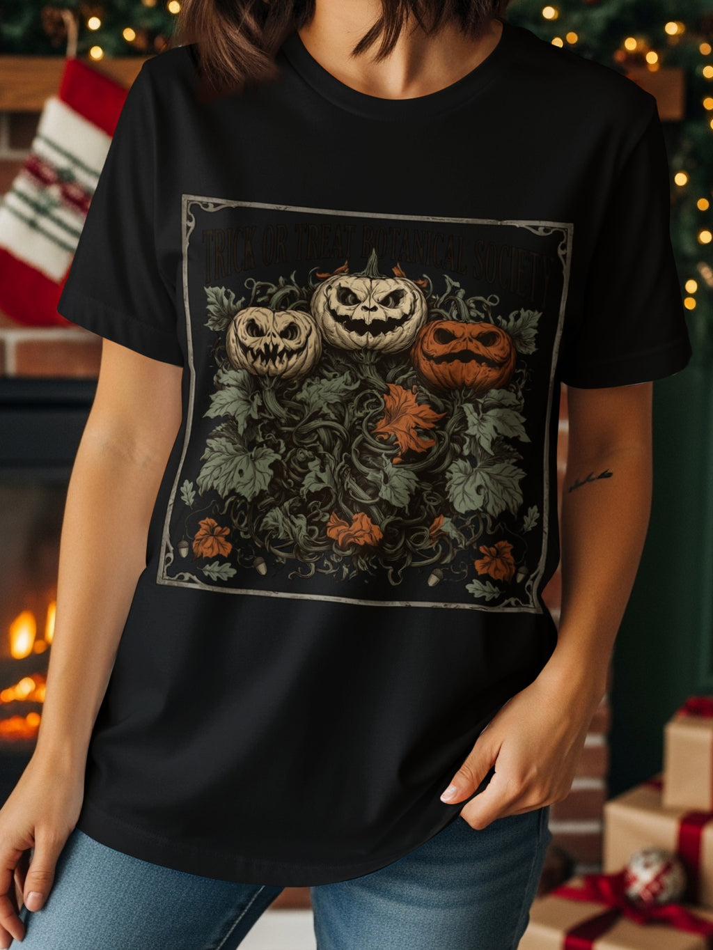 T-shirt with three carved pumpkins and botanical motif. Text reads "Trick or Treat Botanical Society".