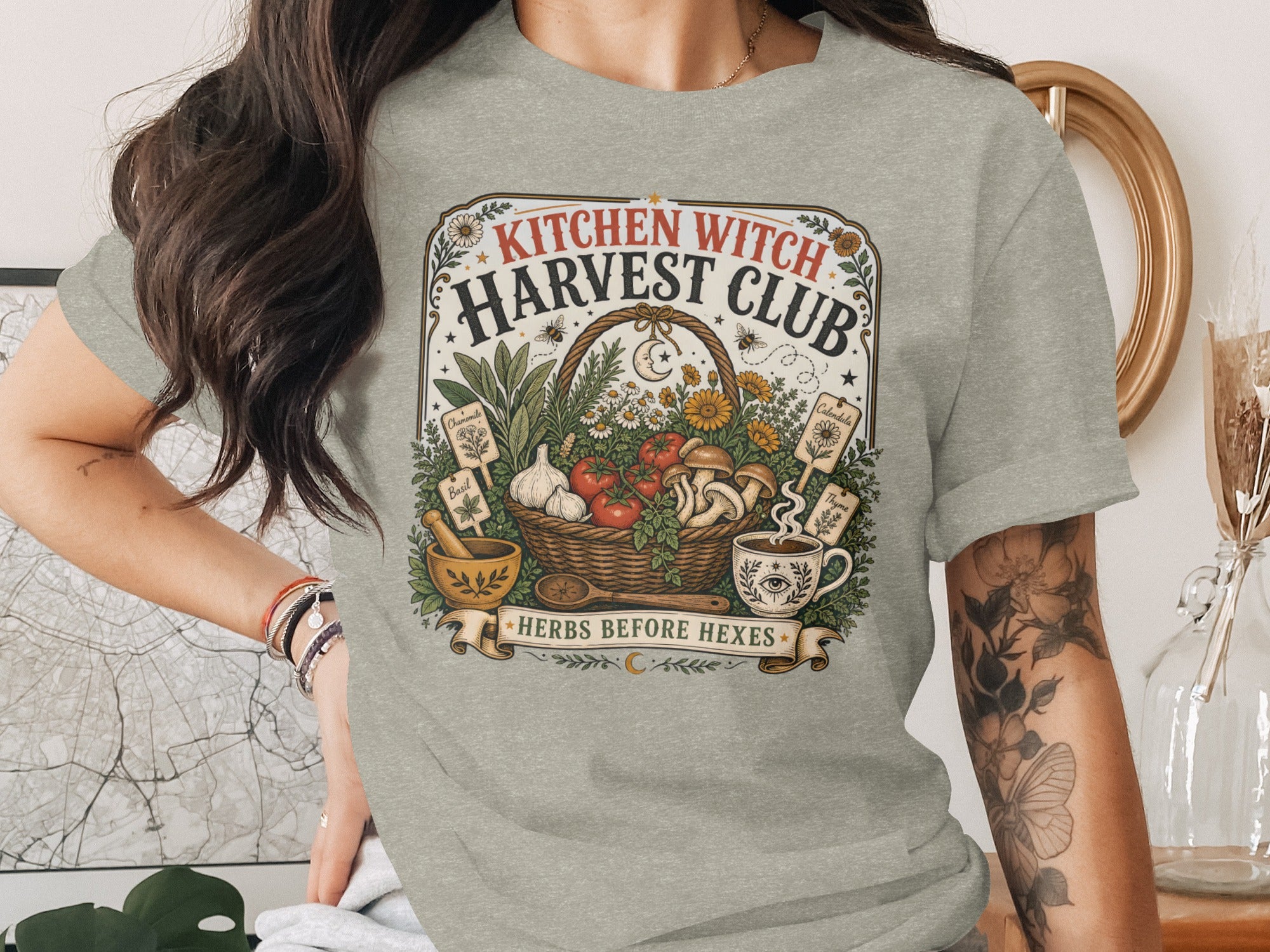 Kitchen Witch Harvest Club graphic on t-shirt with basket of produce and herbs.