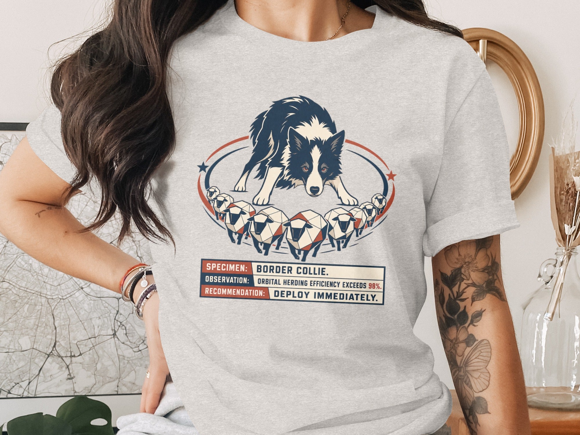 T-shirt graphic of a Border Collie herding sheep with text "SPECIMEN: BORDER COLLIE."