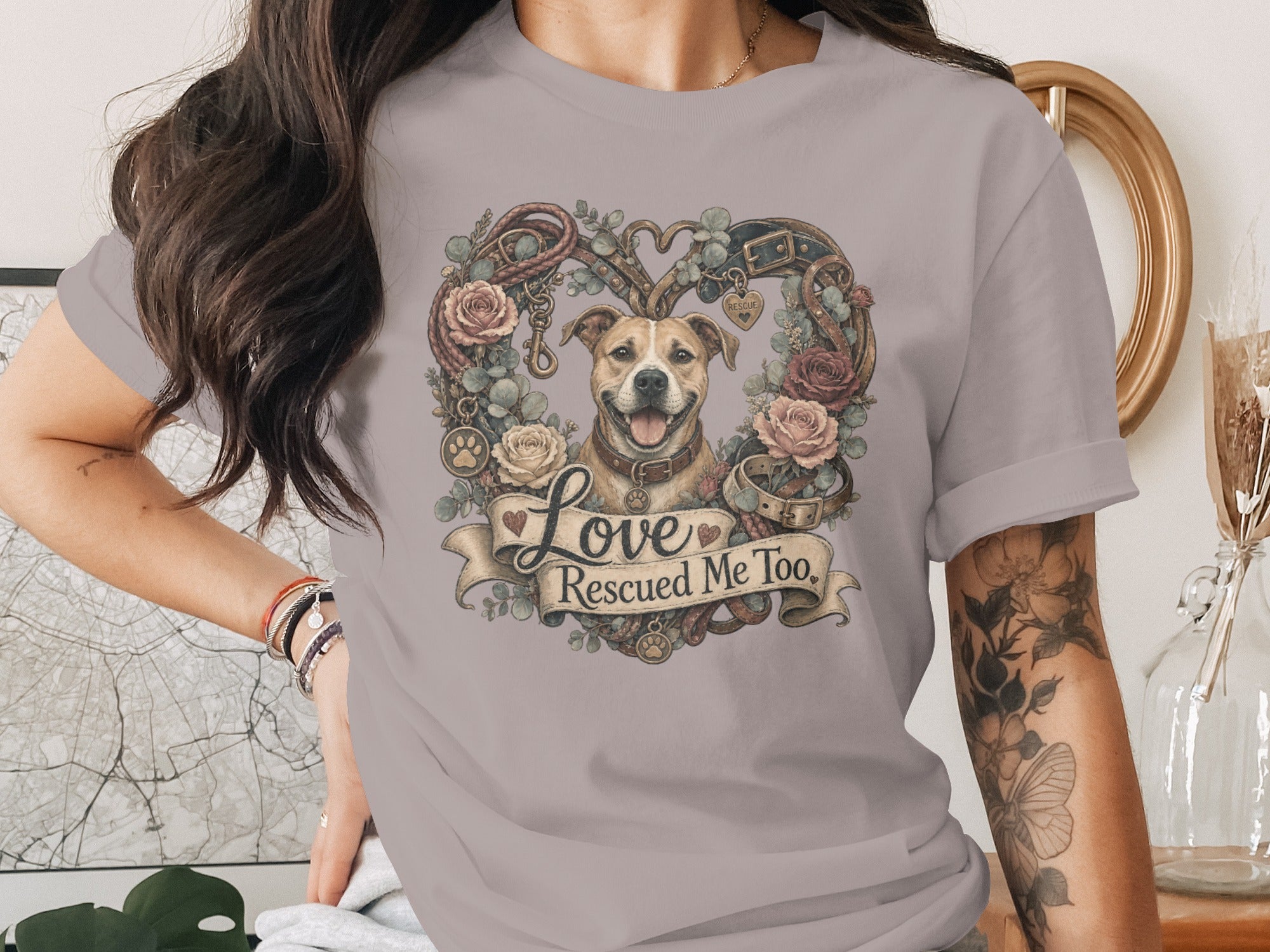Dog surrounded by floral heart wreath with "Love Rescued Me Too" banner.