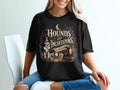 Black shirt with "Hounds and Incantations" design featuring a dog, tarot cards, candle, and books.