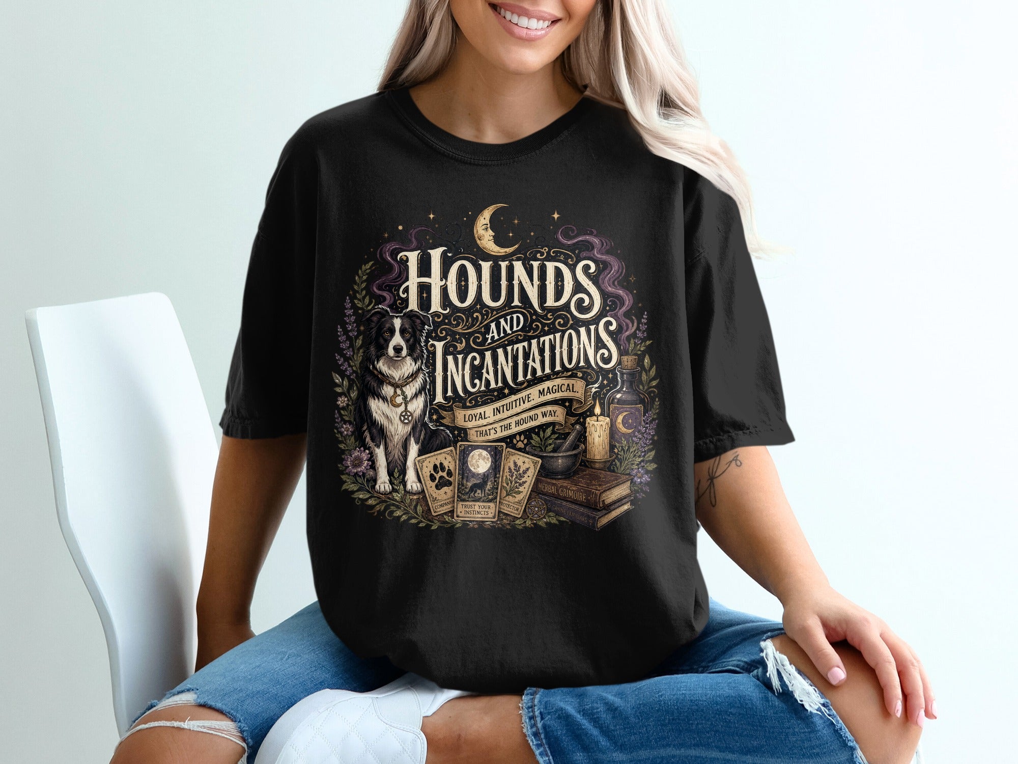 Black shirt with "Hounds and Incantations" design featuring a dog, tarot cards, candle, and books.
