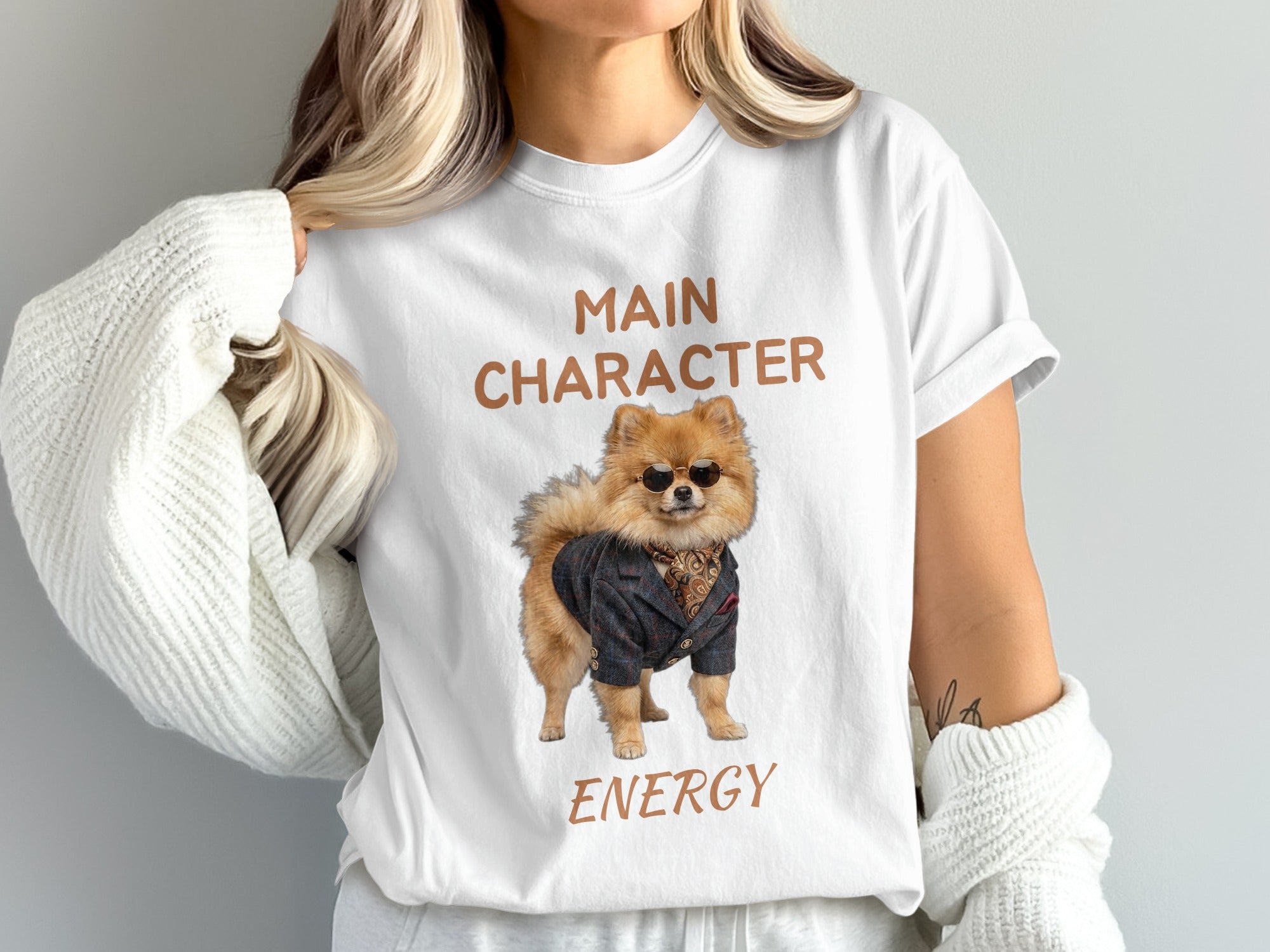 White t-shirt with "MAIN CHARACTER ENERGY" and a Pomeranian in a suit.