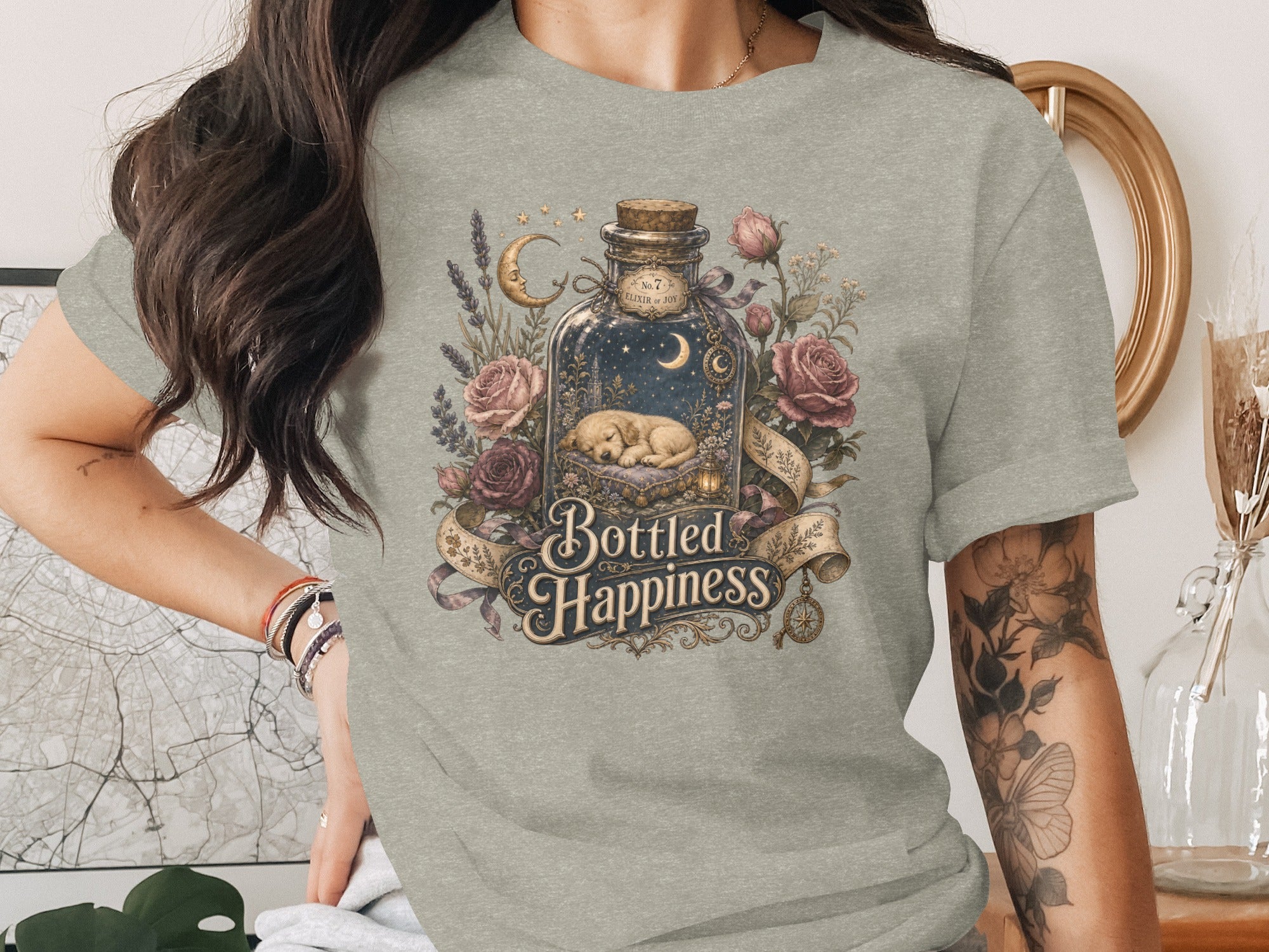 Bottled Happiness graphic on a t-shirt features a sleeping puppy in a starry bottle.