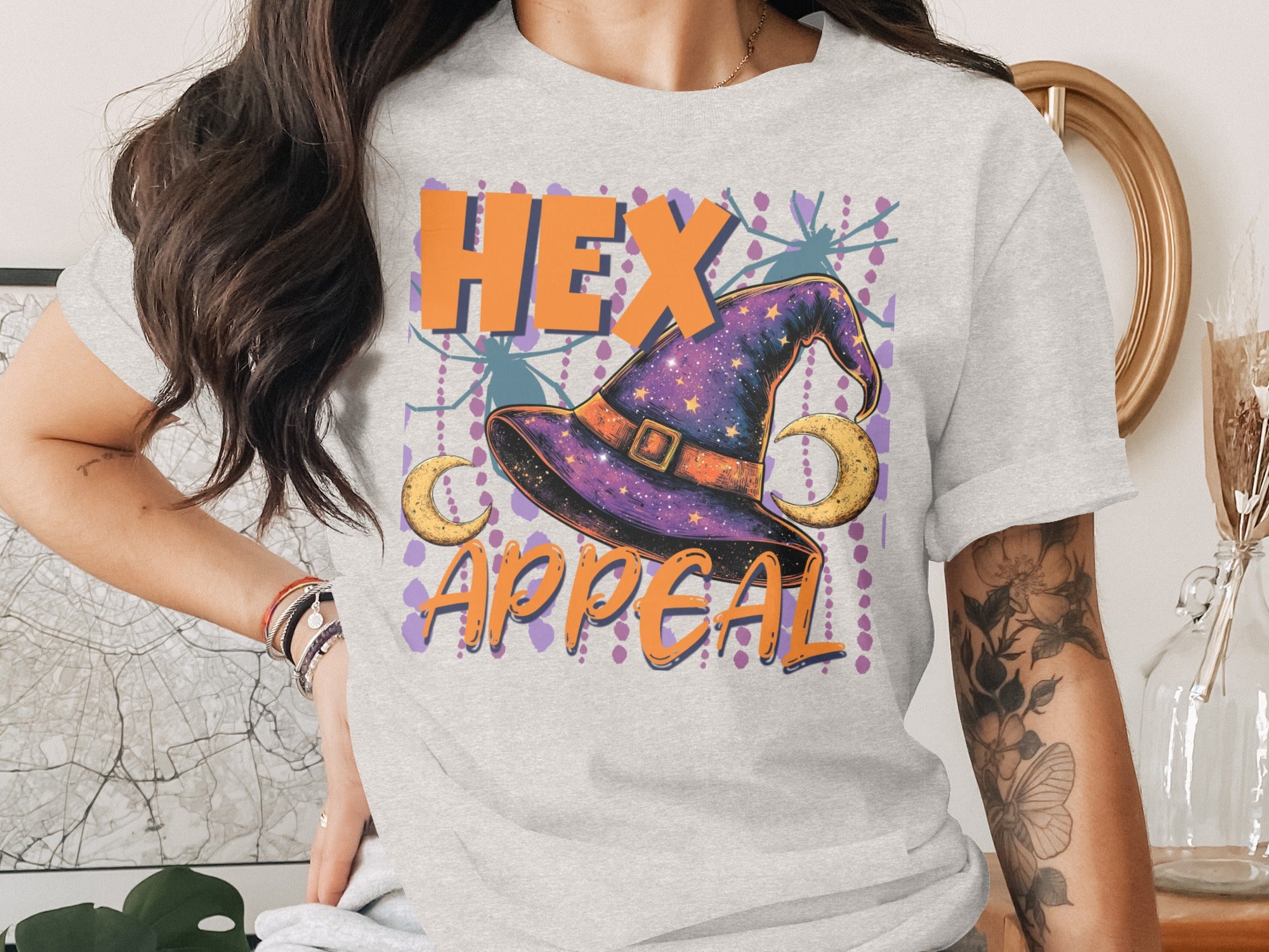 Light grey t-shirt with a Halloween graphic of a hat, moons, and the text "HEX APPEAL".