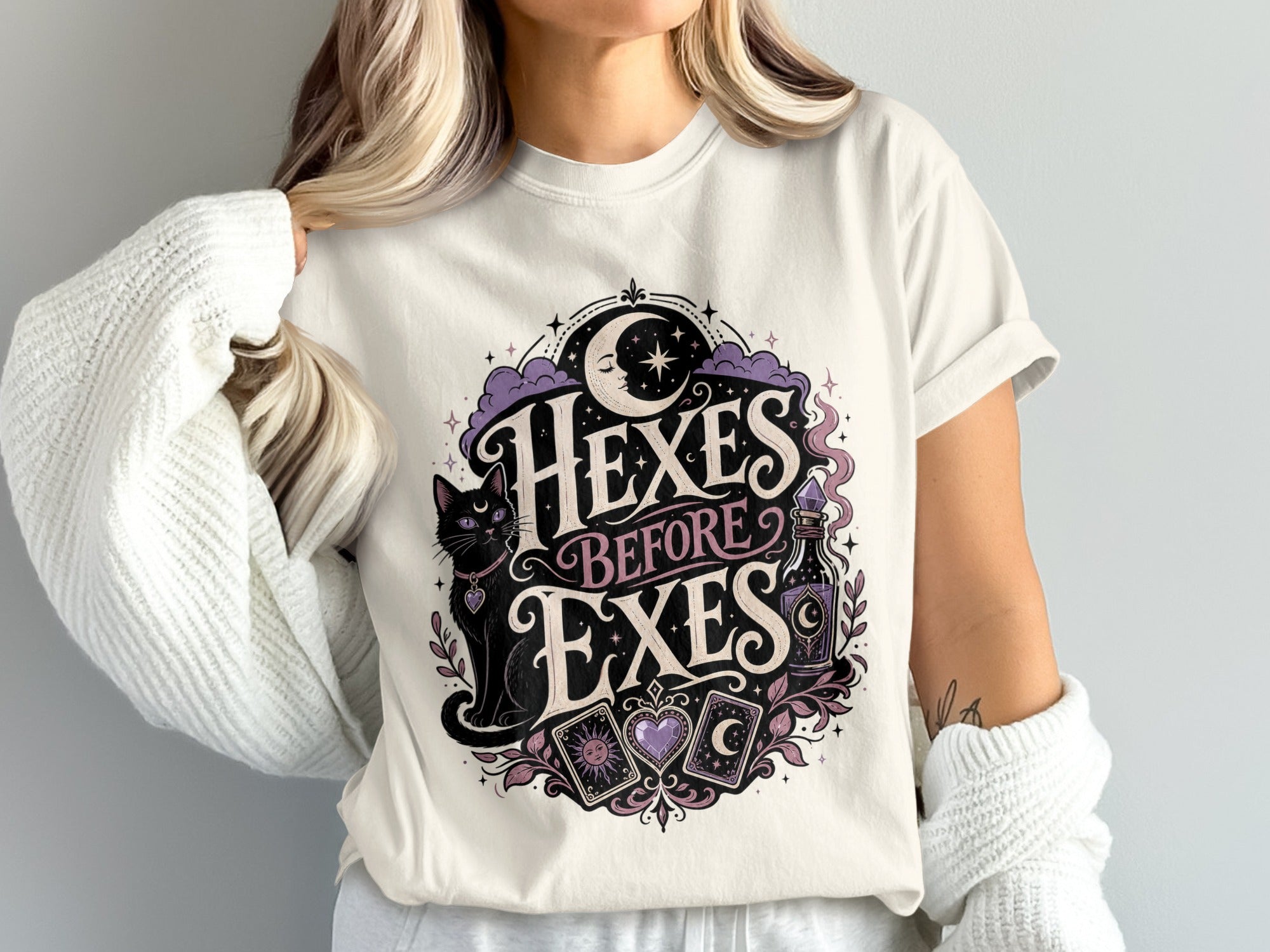 Cream t-shirt with "Hexes Before Exes" text, black cat, potion, and tarot cards.