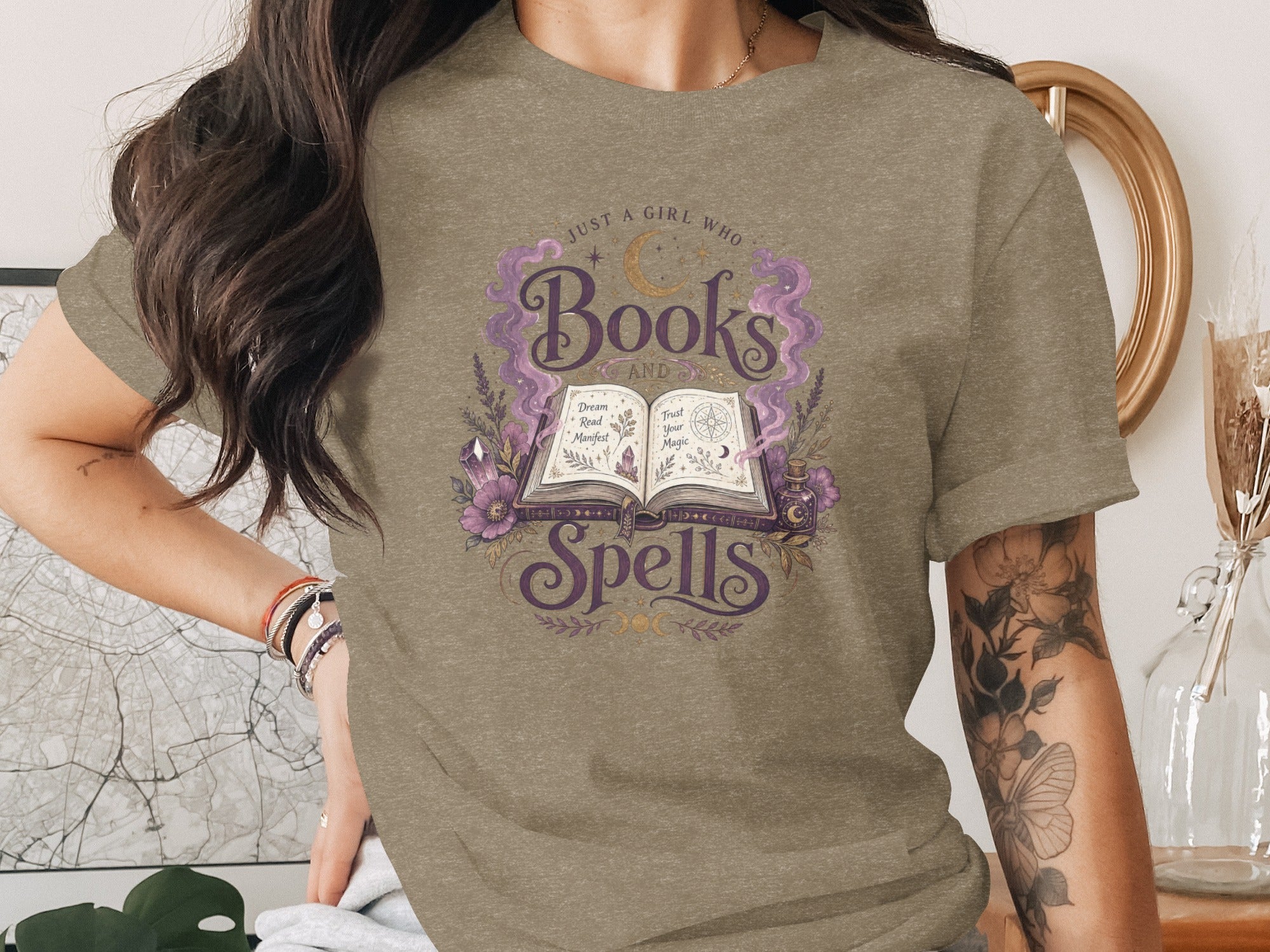 "Just a girl who loves Books and Spells" graphic tee with magical imagery.