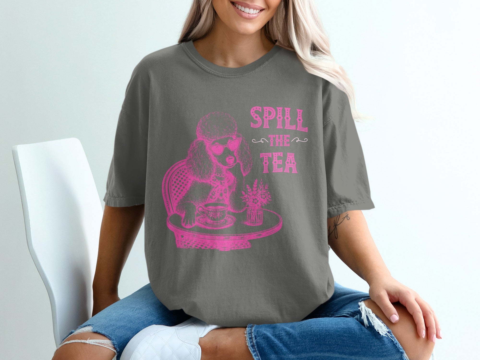 T-shirt with pink graphic of poodle wearing sunglasses at a table with tea and flowers.