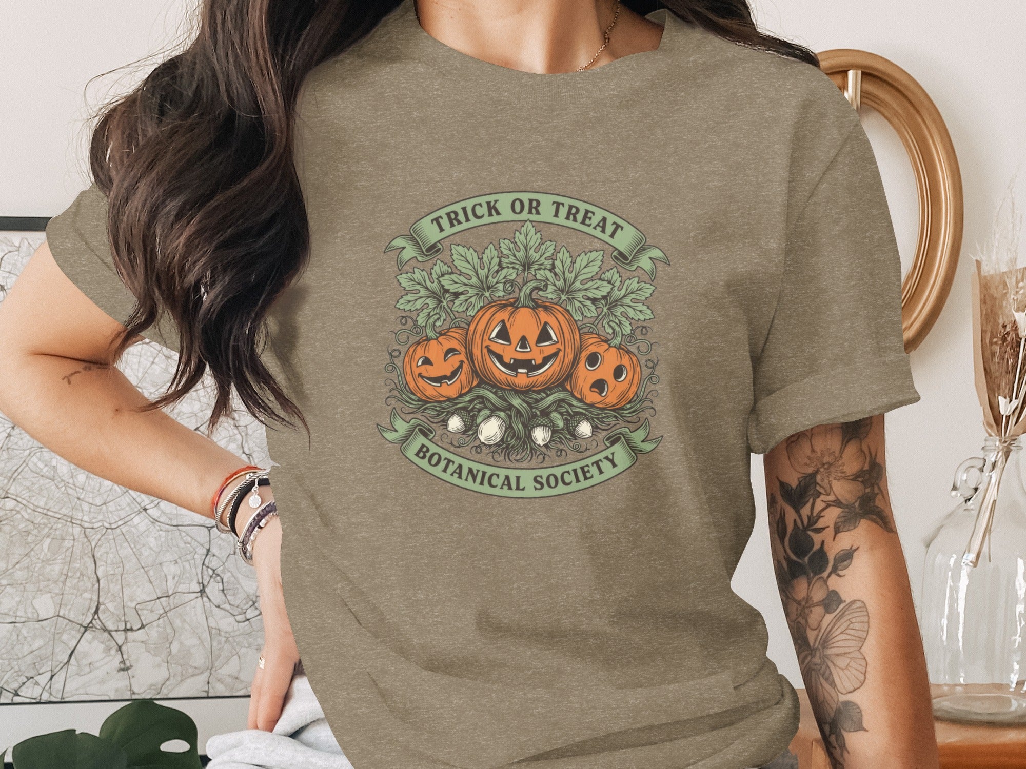T-shirt with pumpkins, leaves, and text "Trick or Treat Botanical Society".
