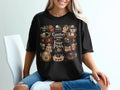 Black t-shirt with "Comfort Comes With Four Paws" and puppies in cozy sweaters.