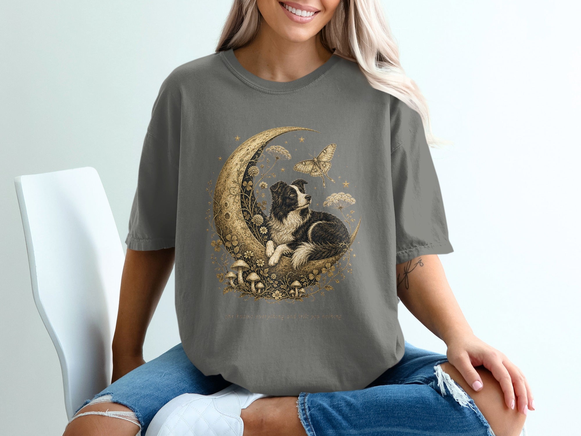 Border collie on moon with stars and butterfly, with text "She sees everything and tells you nothing."