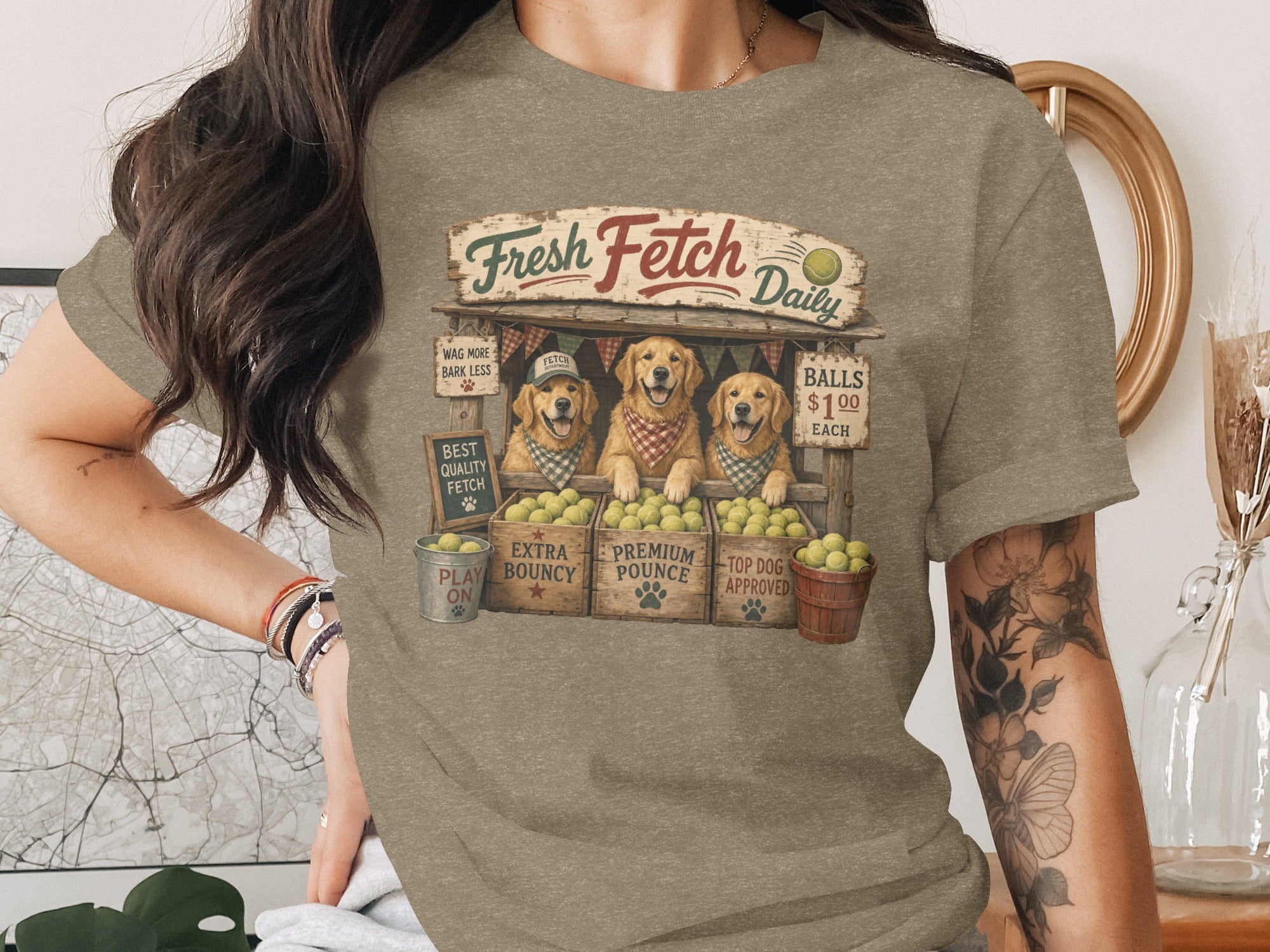 Three golden retrievers at a "Fresh Fetch Daily" stand sell tennis balls.