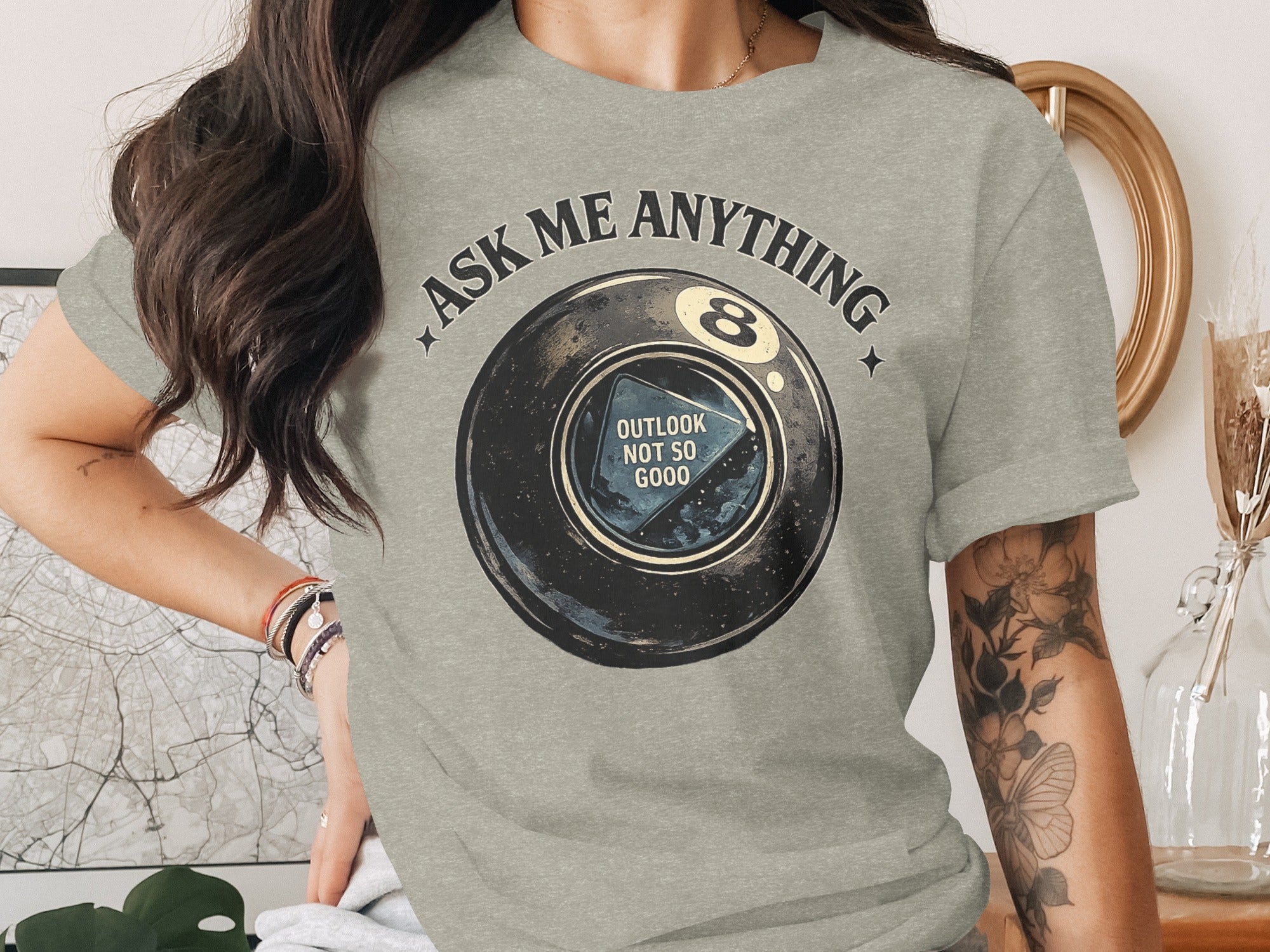Grey t-shirt graphic with "Ask Me Anything" and an 8-ball reading "Outlook Not So Good."