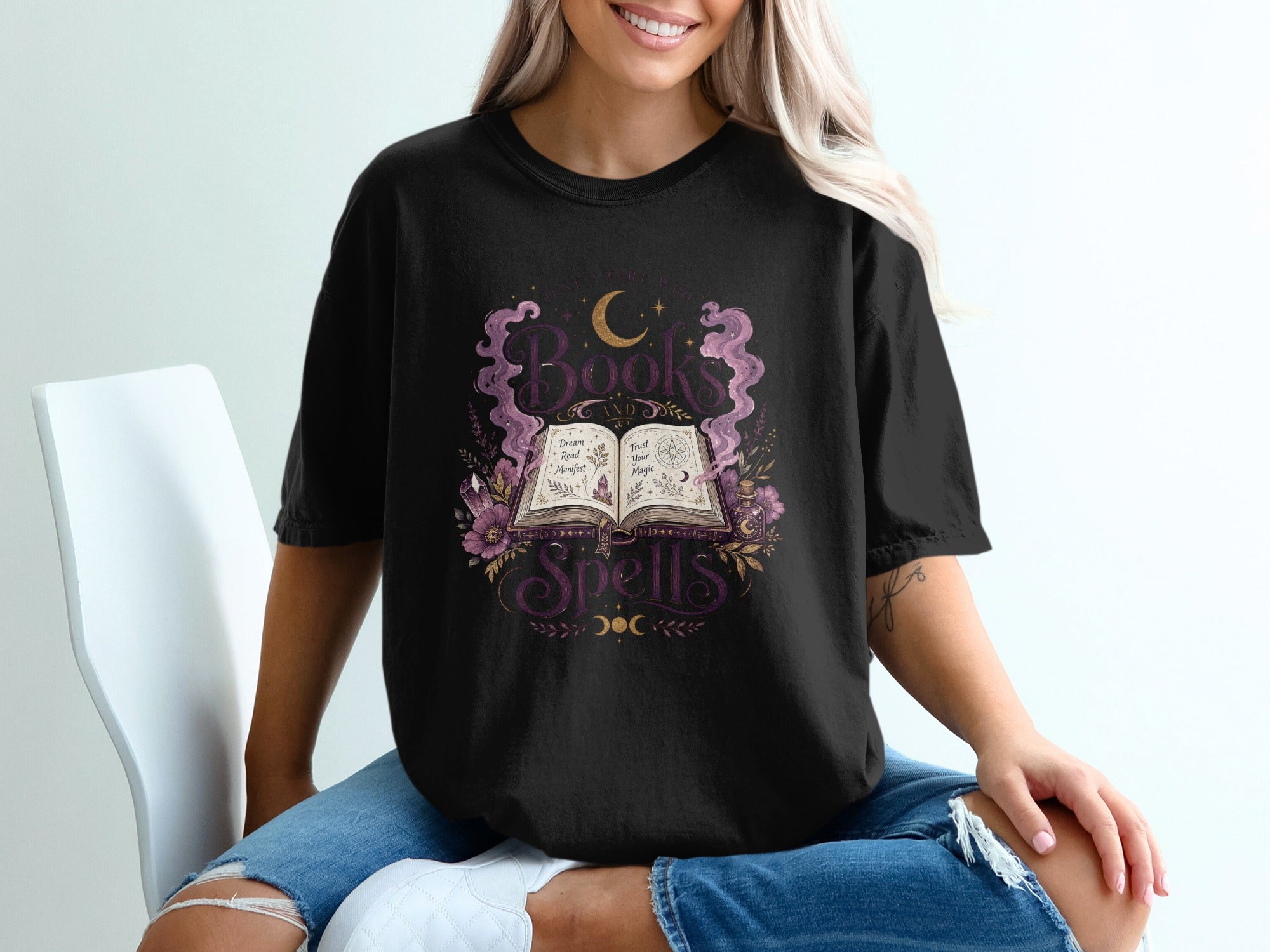Black t-shirt with "Books and Spells" graphic featuring an open book, moon, and flowers.