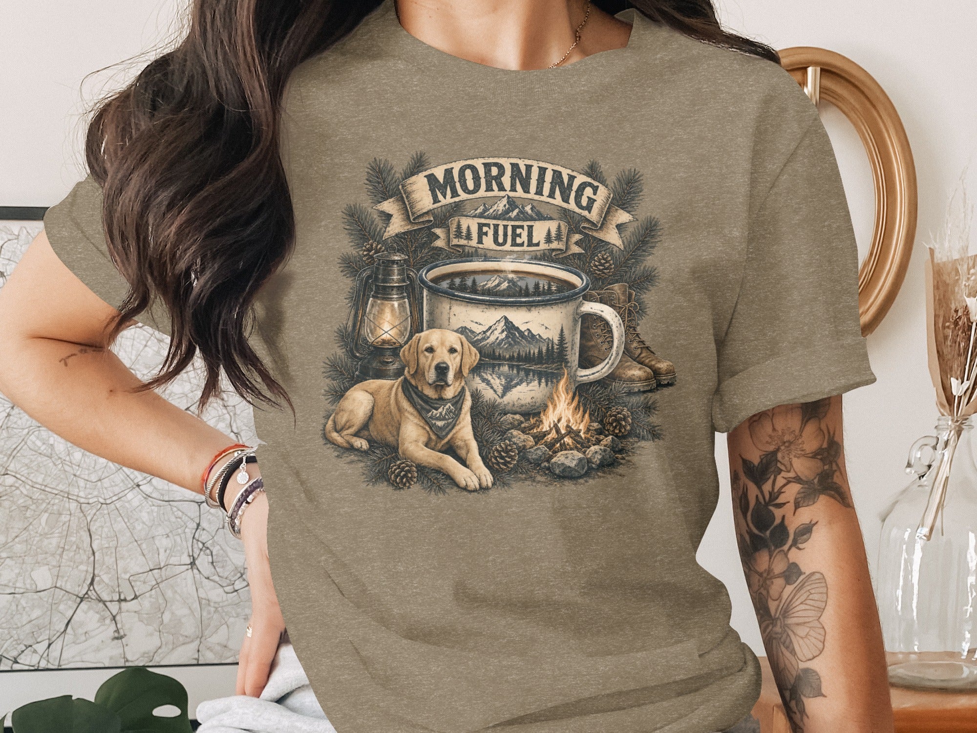 T-shirt with "Morning Fuel" text, campfire, mug, dog, lantern, and boots illustration.
