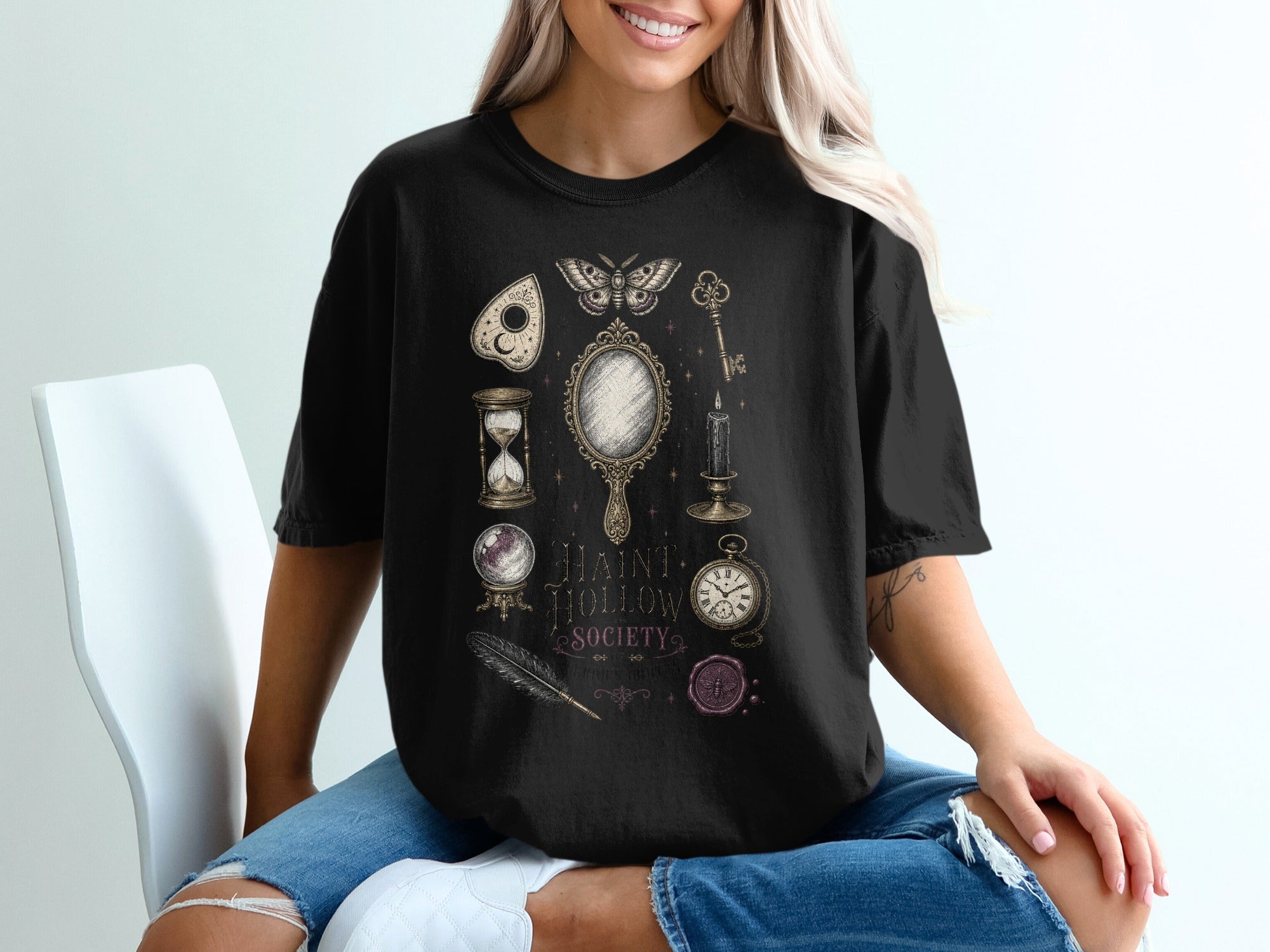 Black t-shirt with "HAINT HOLLOW SOCIETY" and vintage occult illustrations.