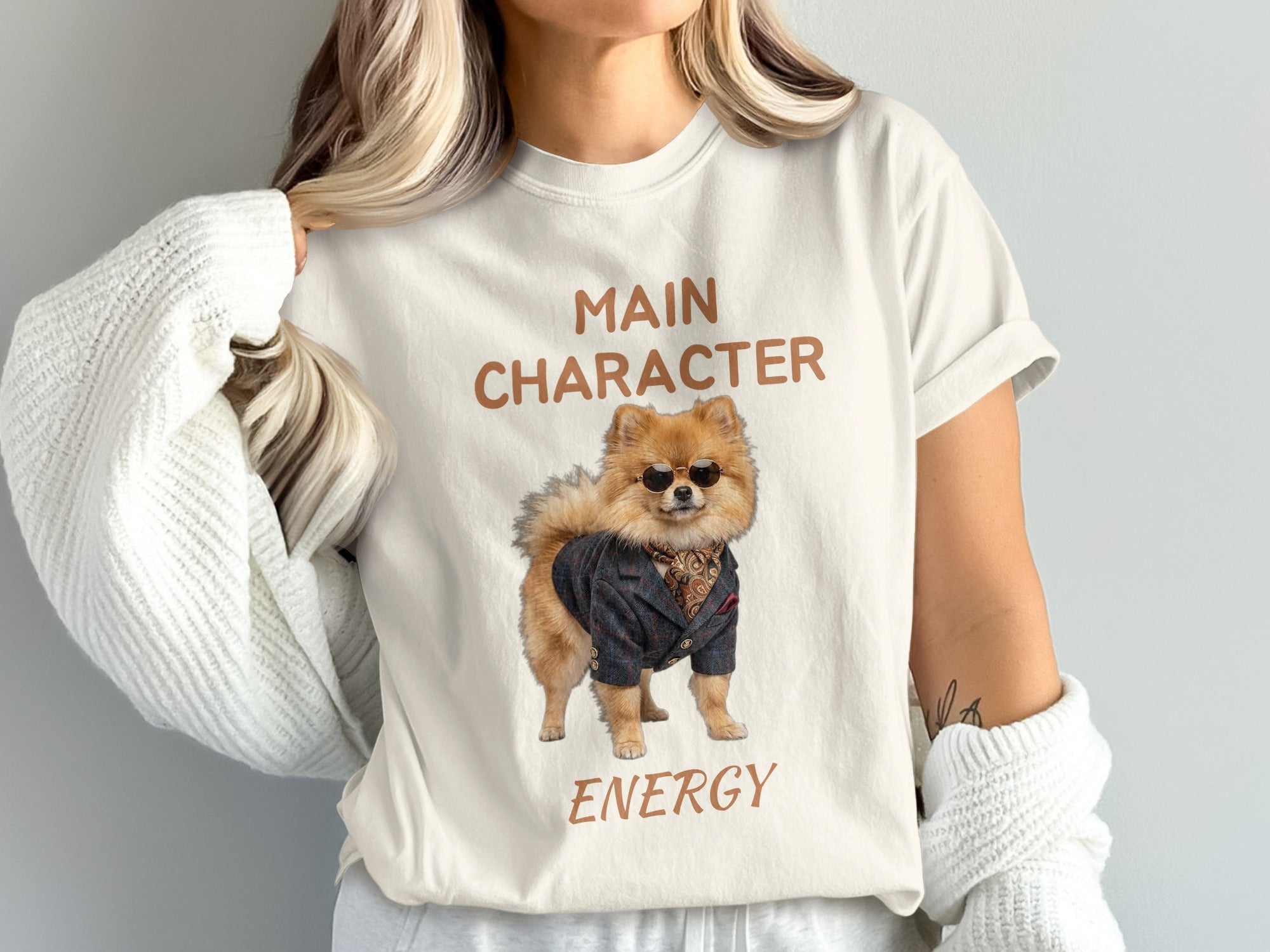 T-shirt with a Pomeranian dog wearing a suit and sunglasses, text "MAIN CHARACTER ENERGY".