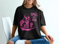 Black t-shirt with pink graphic of poodle wearing sunglasses and "Spill the Tea" text.