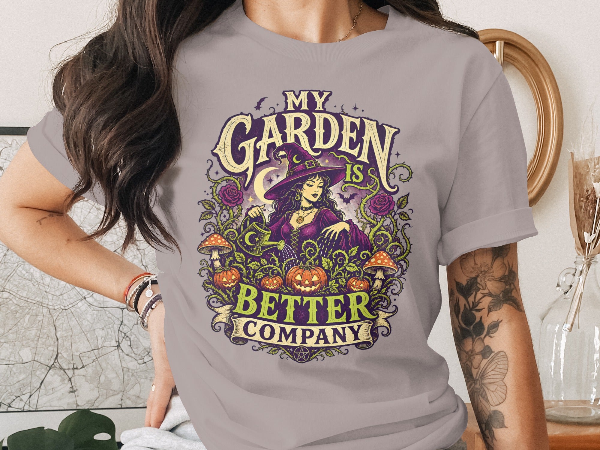 "My Garden Is Better Company" t-shirt featuring a witch, pumpkins, mushrooms, and roses.