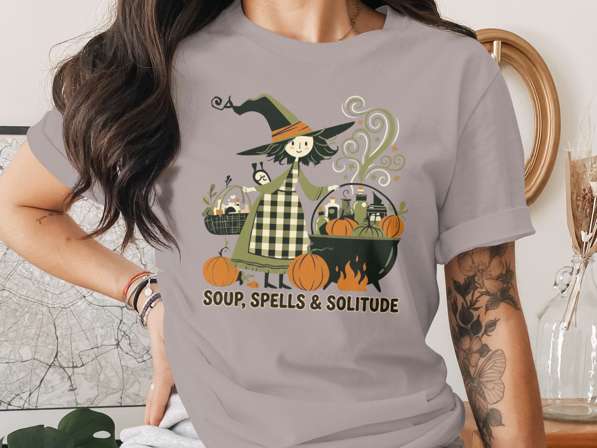 Witch brewing potions with pumpkins and text "SOUP, SPELLS & SOLITUDE."