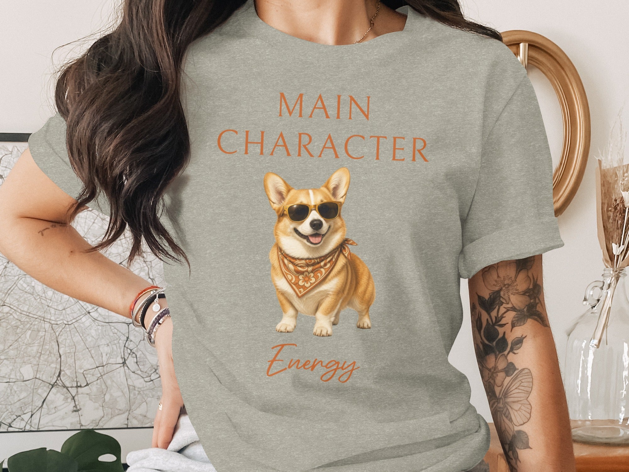 Grey t-shirt with "MAIN CHARACTER Energy" and a corgi wearing sunglasses and bandana.