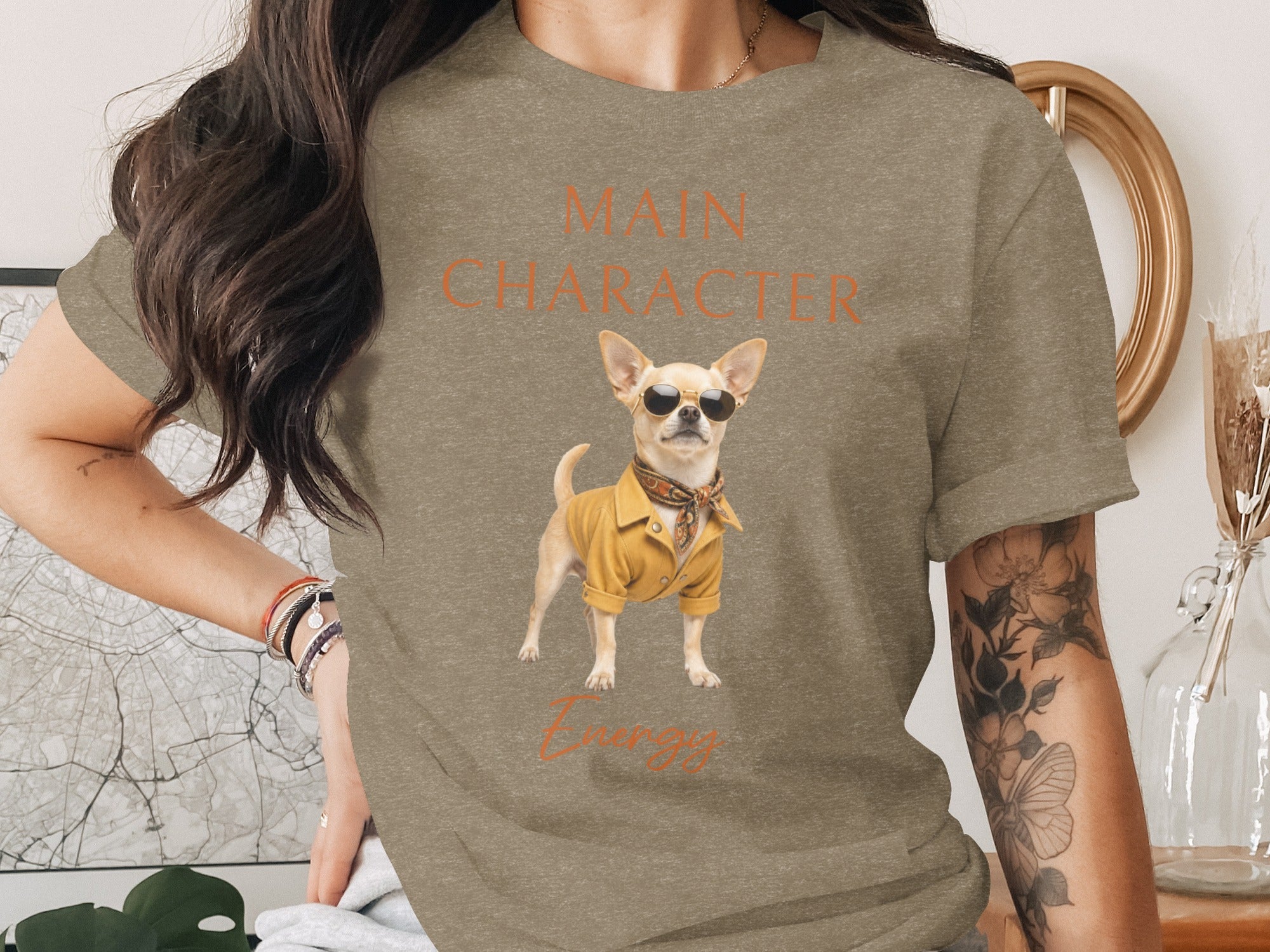 T-shirt graphic of a chihuahua wearing sunglasses and a yellow jacket, with "Main Character Energy" text.