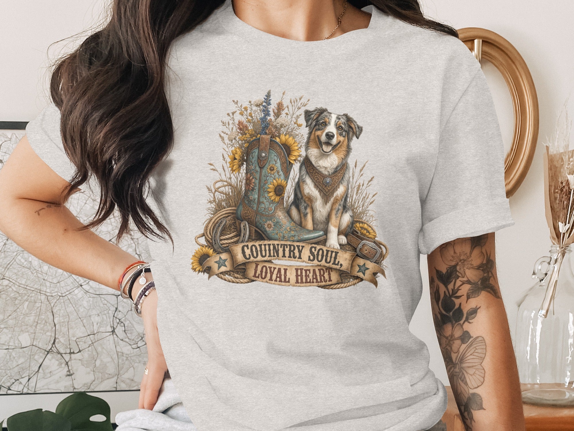 T-shirt graphic with dog, cowboy boot, sunflowers, and banner text "Country Soul, Loyal Heart."