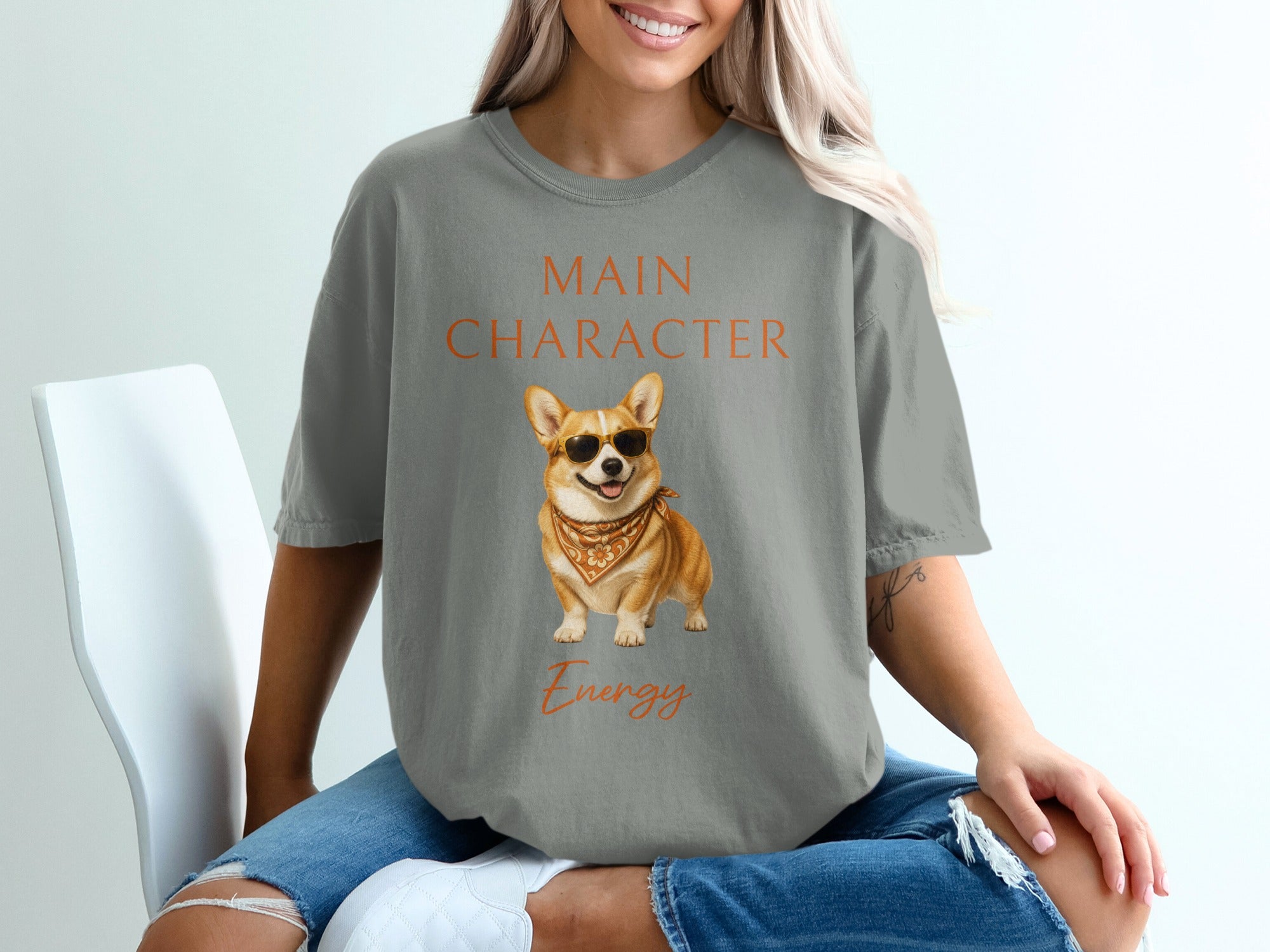 Grey t-shirt with "Main Character Energy" text and a corgi wearing sunglasses.