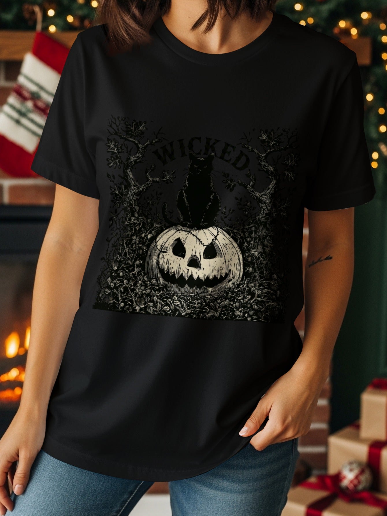 Black t-shirt with a distressed graphic of a black cat sitting on a pumpkin, with the word "wicked".