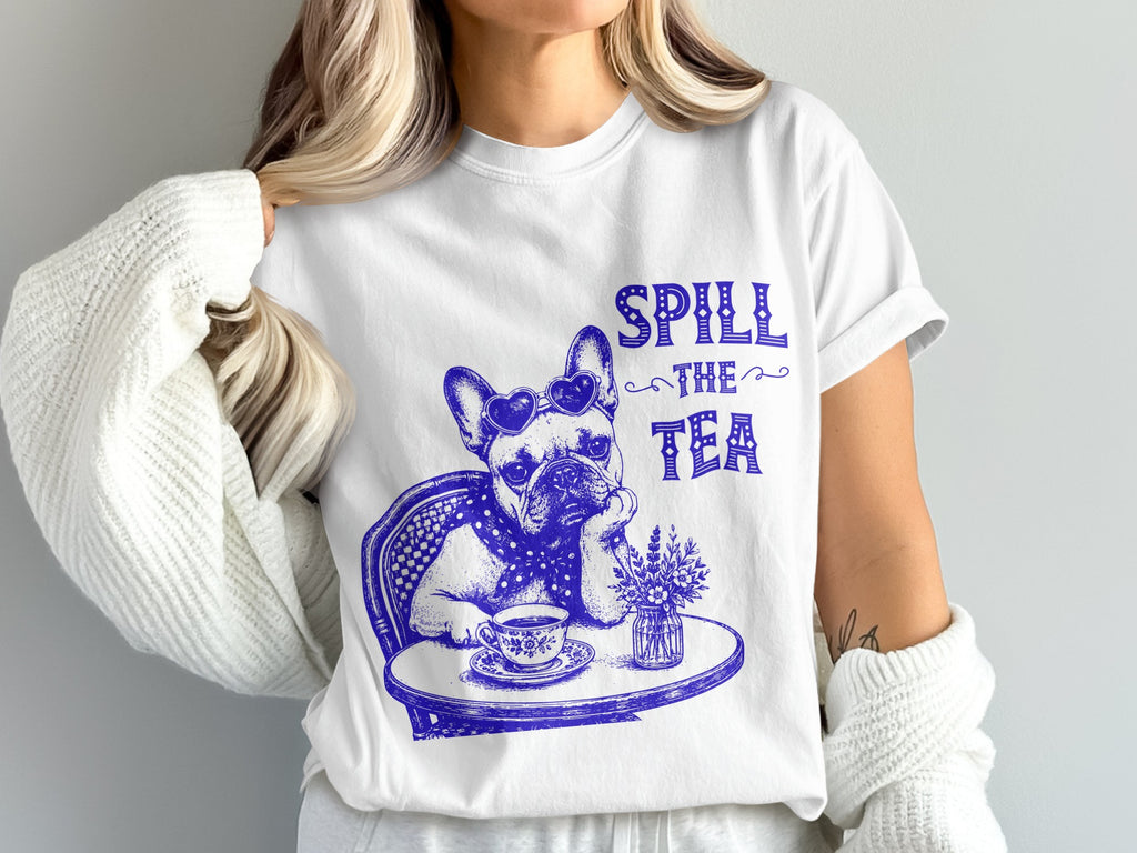 White t-shirt with blue graphic of French bulldog wearing heart sunglasses, drinking tea.