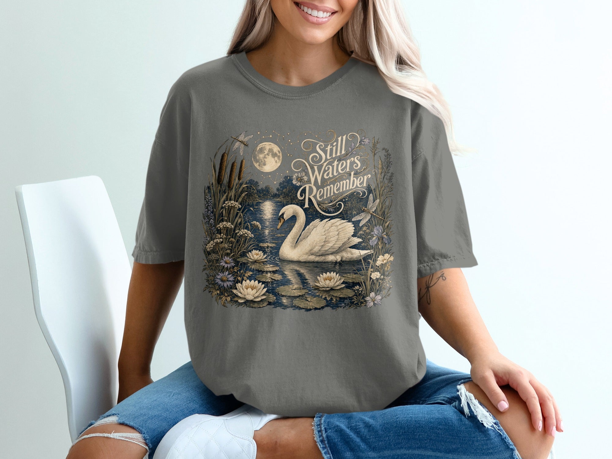Swan on tranquil pond with moon and text "Still Waters Remember."