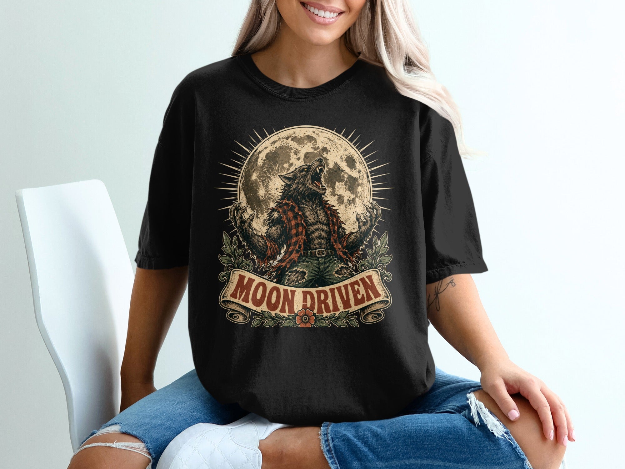 Black t-shirt with a werewolf illustration under a full moon, text reads "Moon Driven."