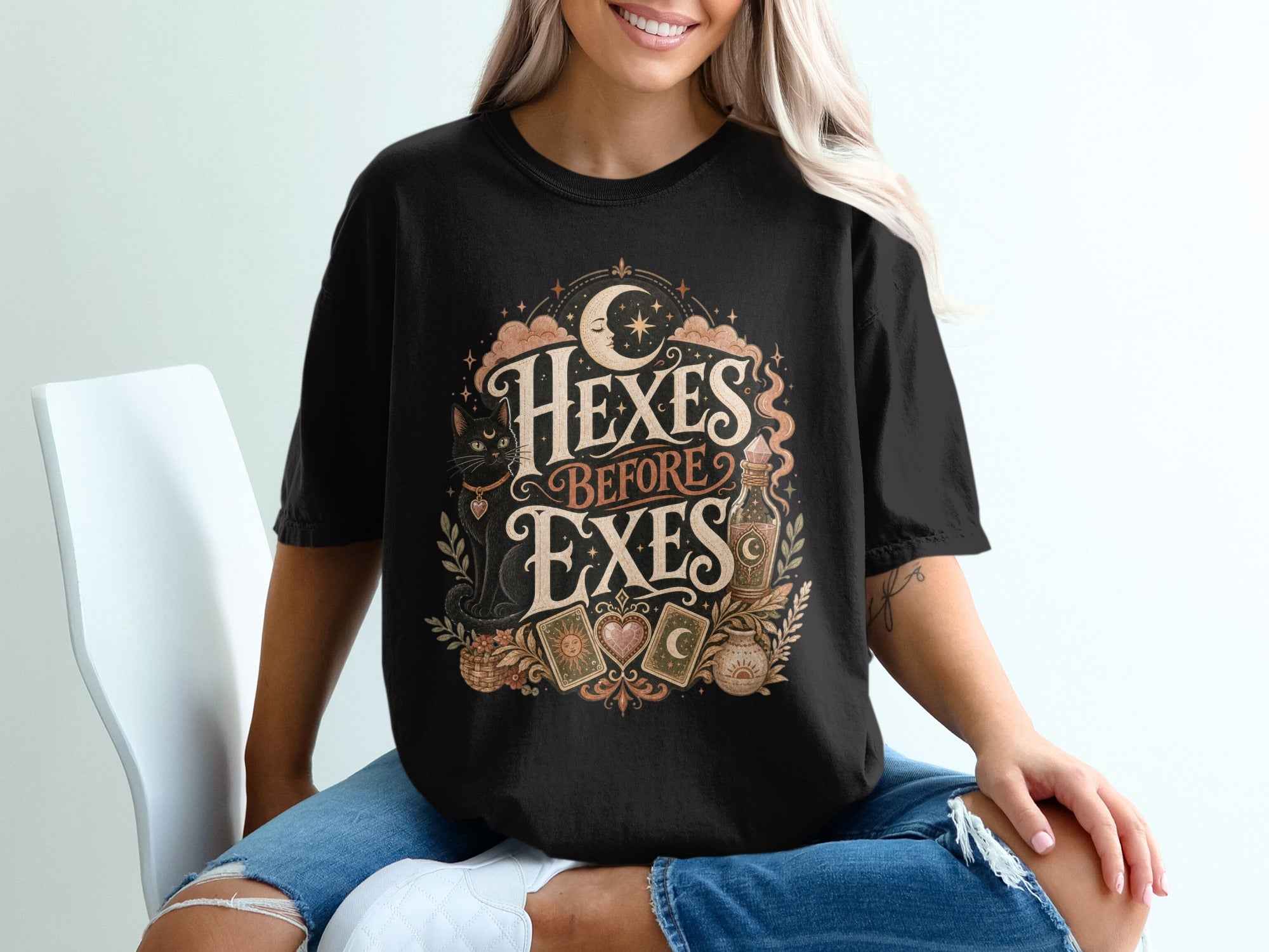 Black t-shirt with moon, stars, black cat, and "Hexes Before Exes" text.