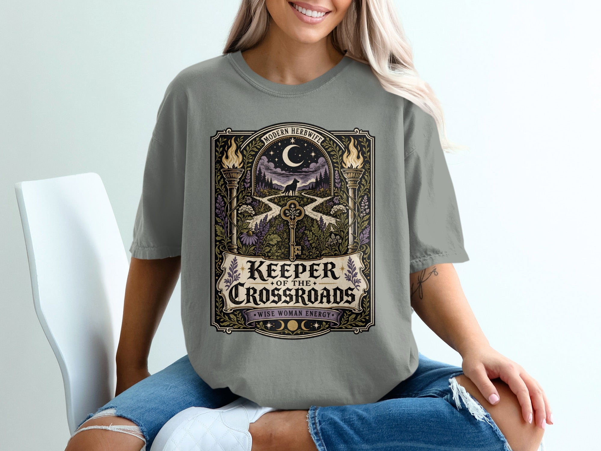 Grey t-shirt with "Keeper of the Crossroads" text and a night scene.