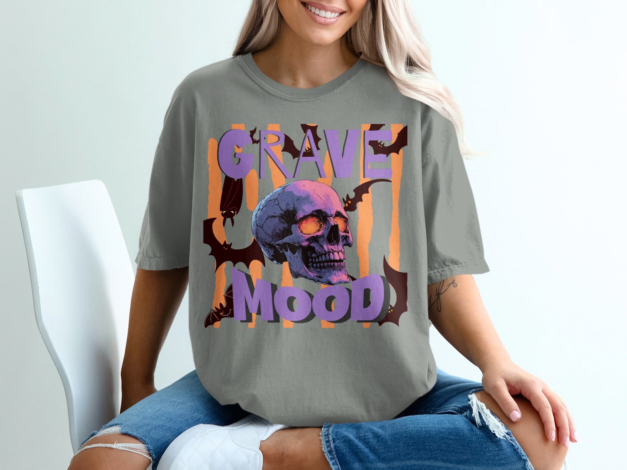 Gray t-shirt with a skull, bats, and the text "Grave Mood".