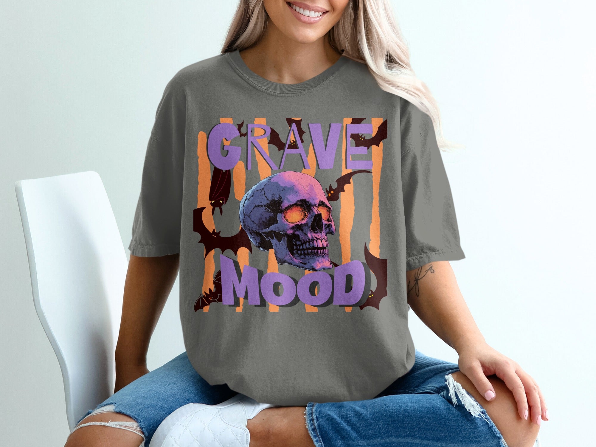 Graveyard mood text with a purple skull and bats on a gray t-shirt.
