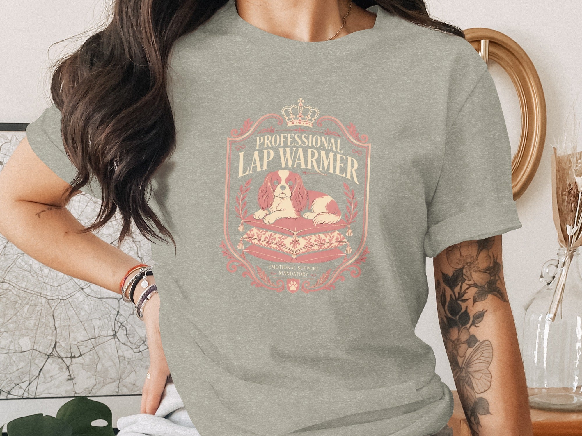 T-shirt with "Professional Lap Warmer" text, crown, and Cavalier King Charles Spaniel on pillows.