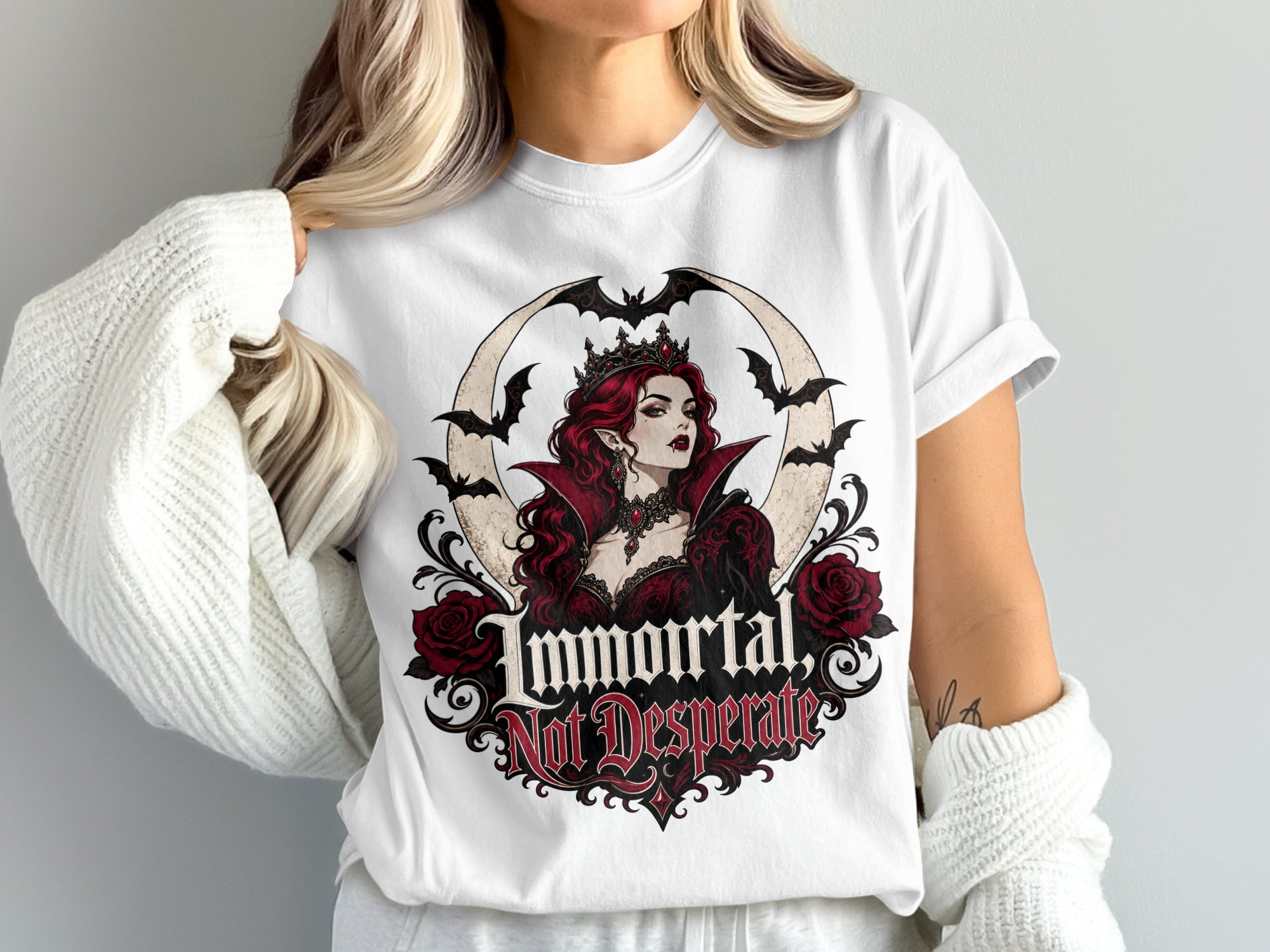 White t-shirt with a circular gothic design featuring a vampire queen, bats, roses, and text.