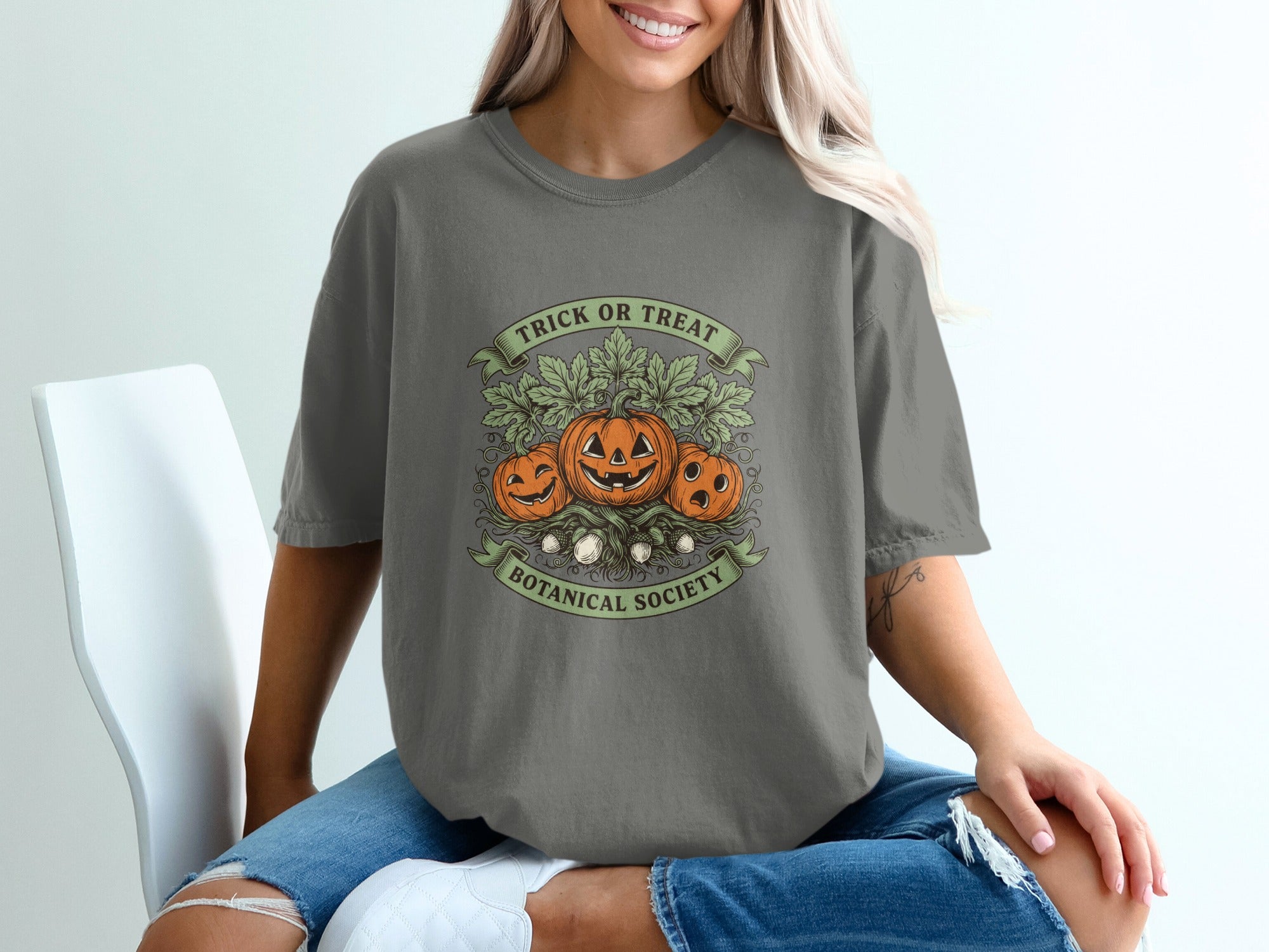 Grey t-shirt with pumpkins and text "Trick or Treat Botanical Society".