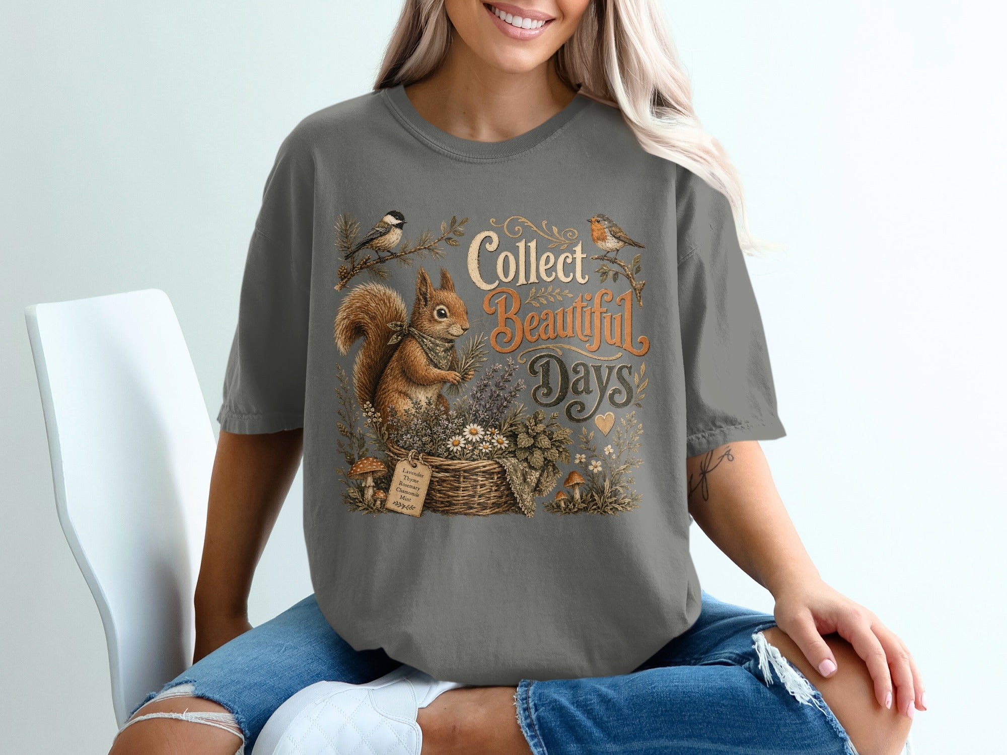 T-shirt graphic with squirrel, birds, basket of herbs, and text "Collect Beautiful Days".