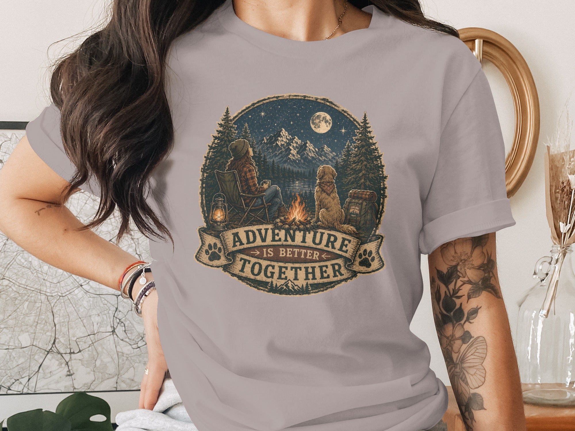 T-shirt graphic: campfire scene with person and dog, says "Adventure is Better Together."
