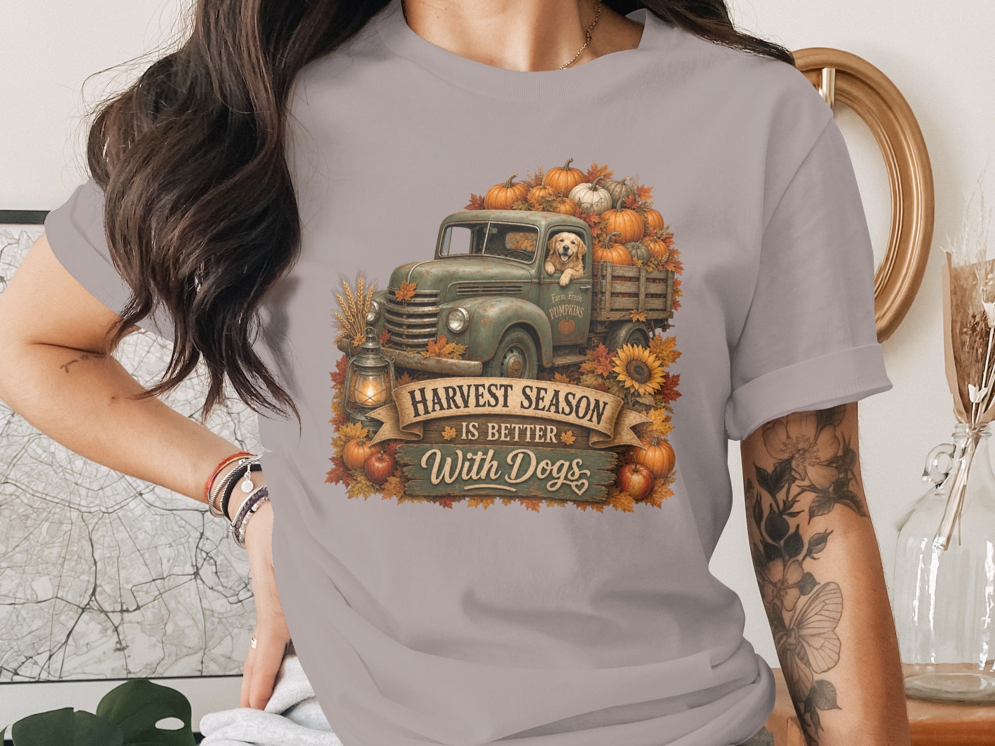 Green truck overflowing with pumpkins, dog, and text "Harvest Season Is Better With Dogs".