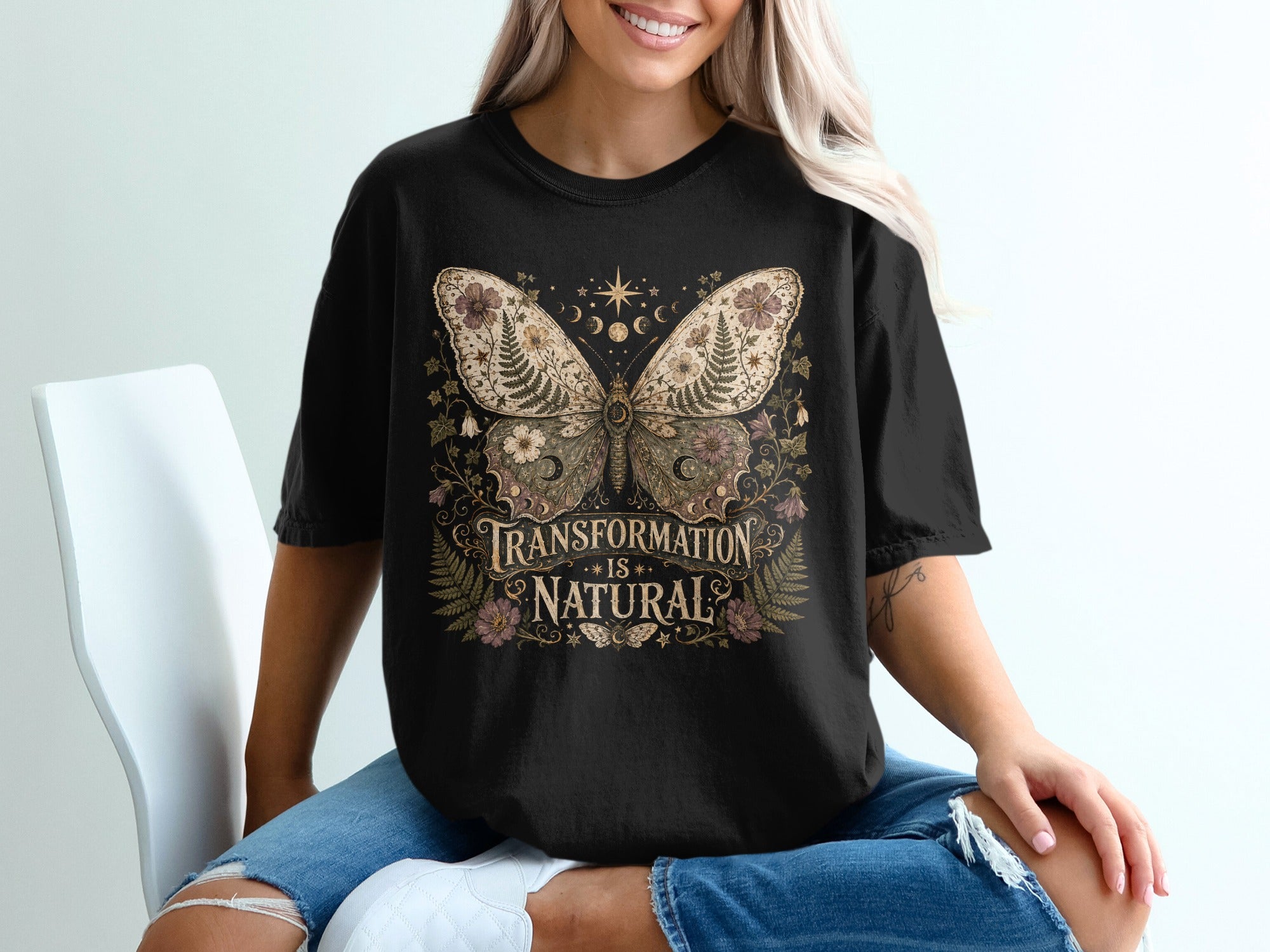 Black t-shirt with a butterfly graphic and text "Transformation is Natural".