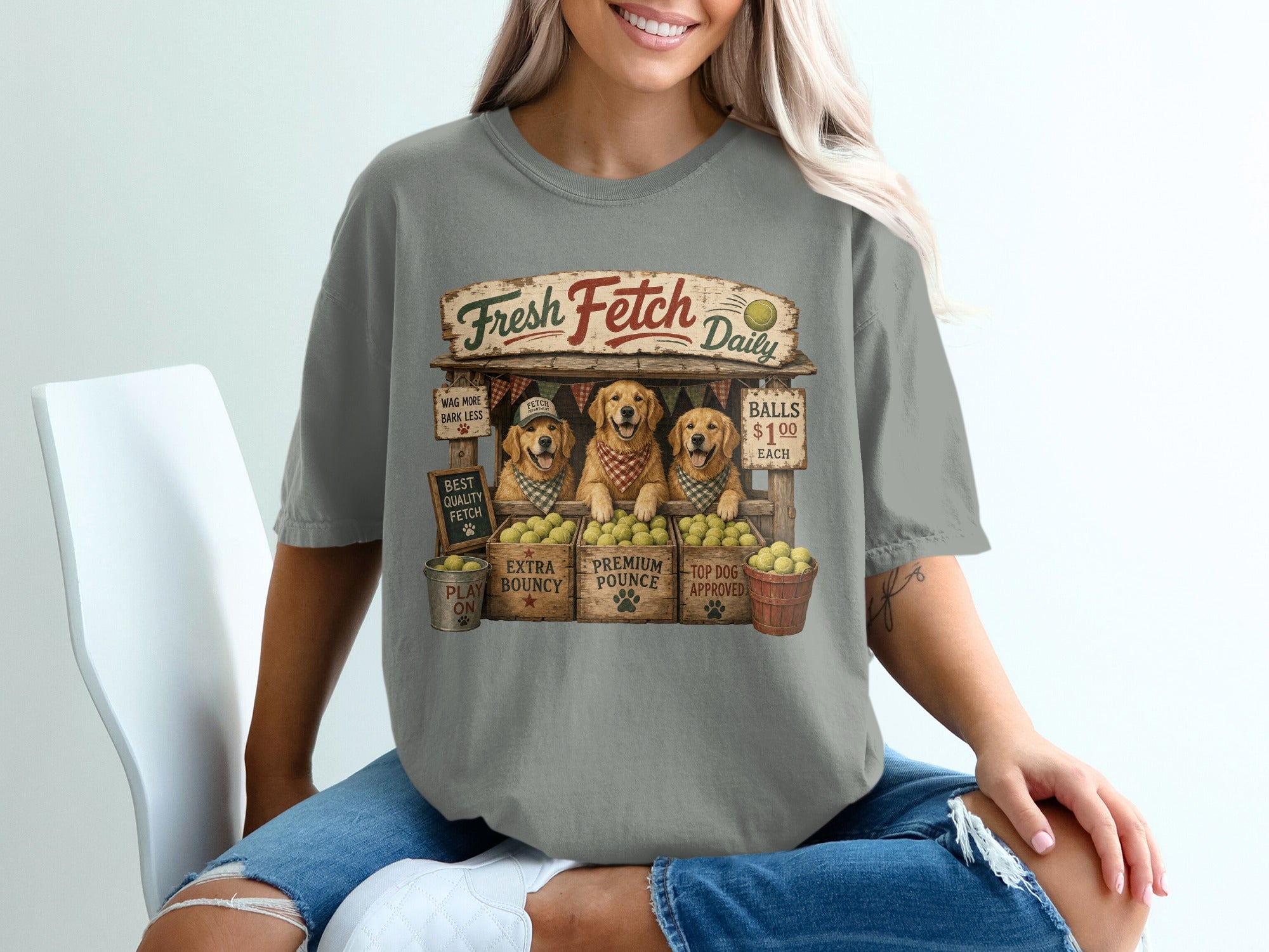 Three Golden Retrievers sell balls under a Fresh Fetch Daily sign.