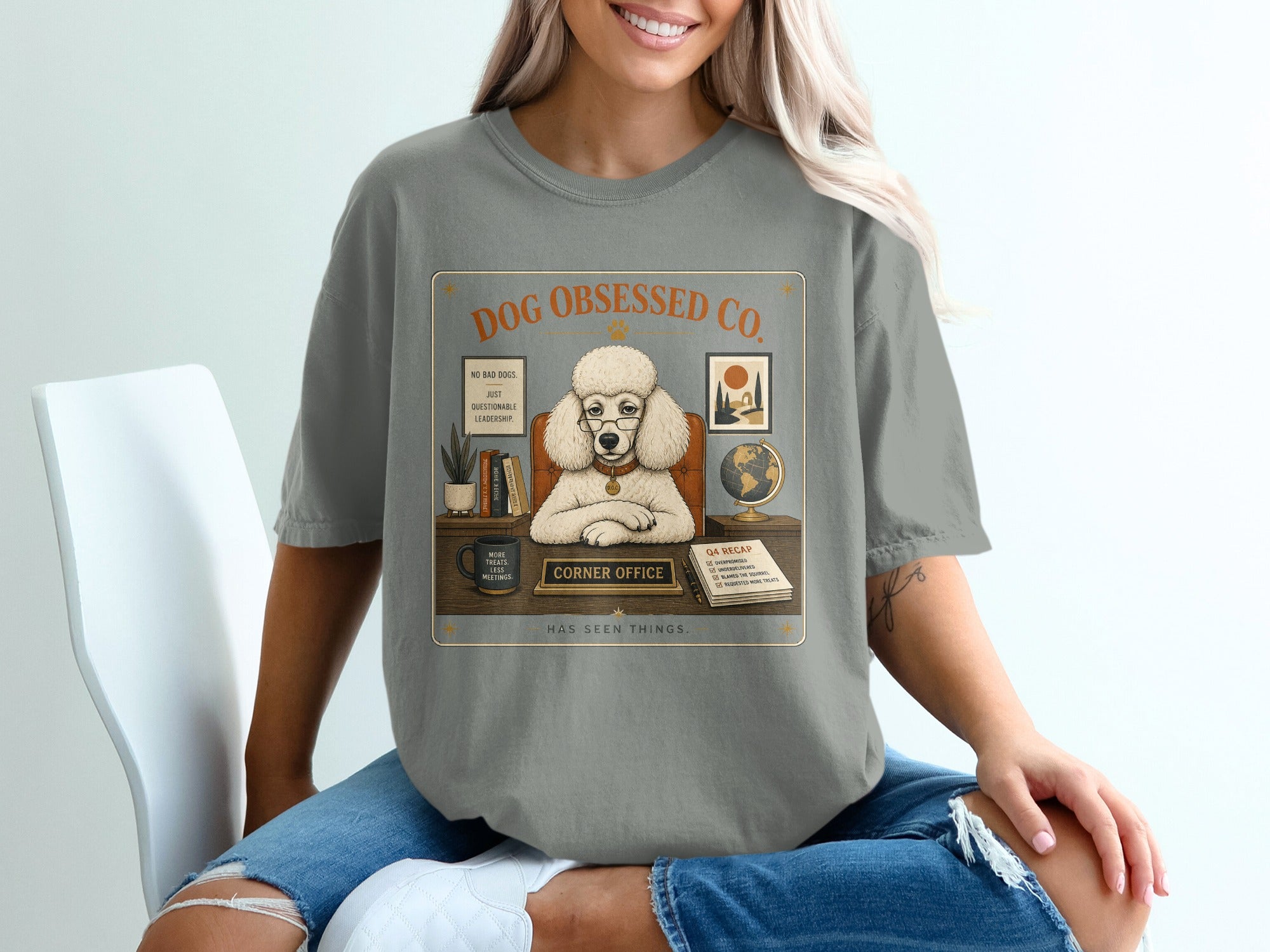 Shirt featuring a poodle in a corner office desk setting with humorous captions.