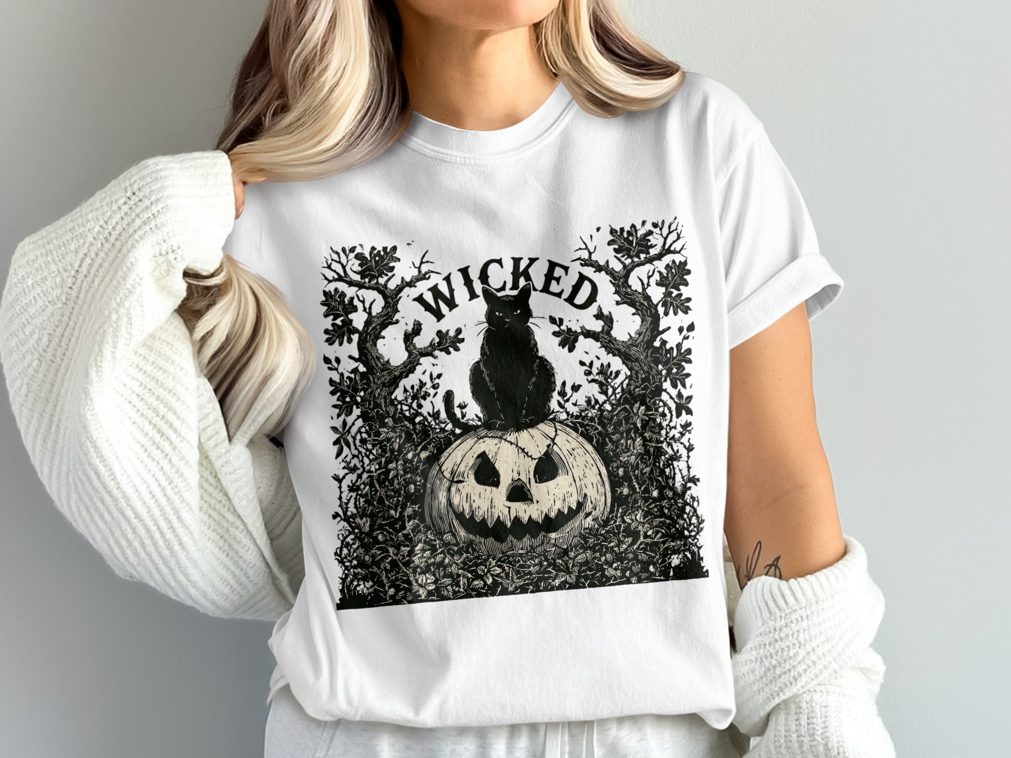 Black cat on jack-o'-lantern with "WICKED" text and trees.