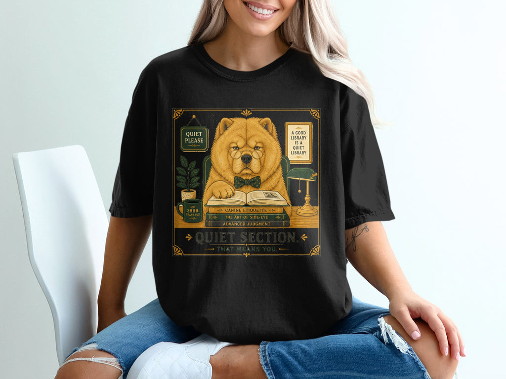 Chow chow dog wearing glasses and bowtie, reading at a desk in a library.