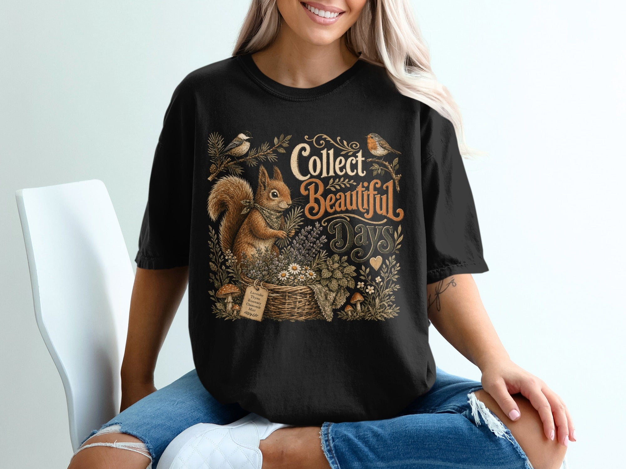 Black t-shirt with squirrel, birds, flowers, and text saying "Collect Beautiful Days".