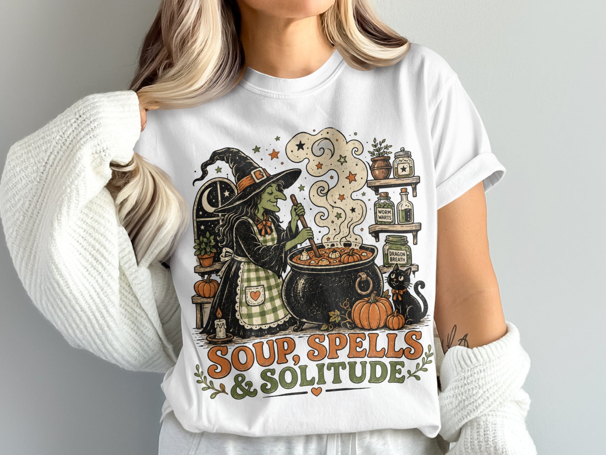 Witch making soup with black cat, pumpkins, and text "Soup, Spells & Solitude".
